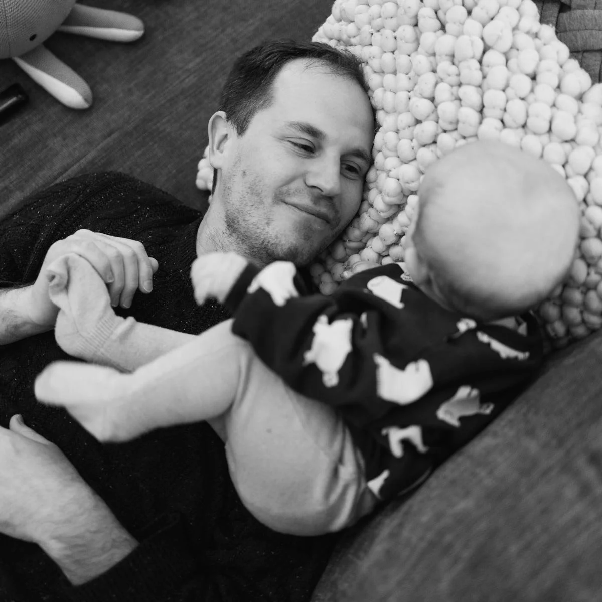 Ross and his daughter on the couch being a present dad