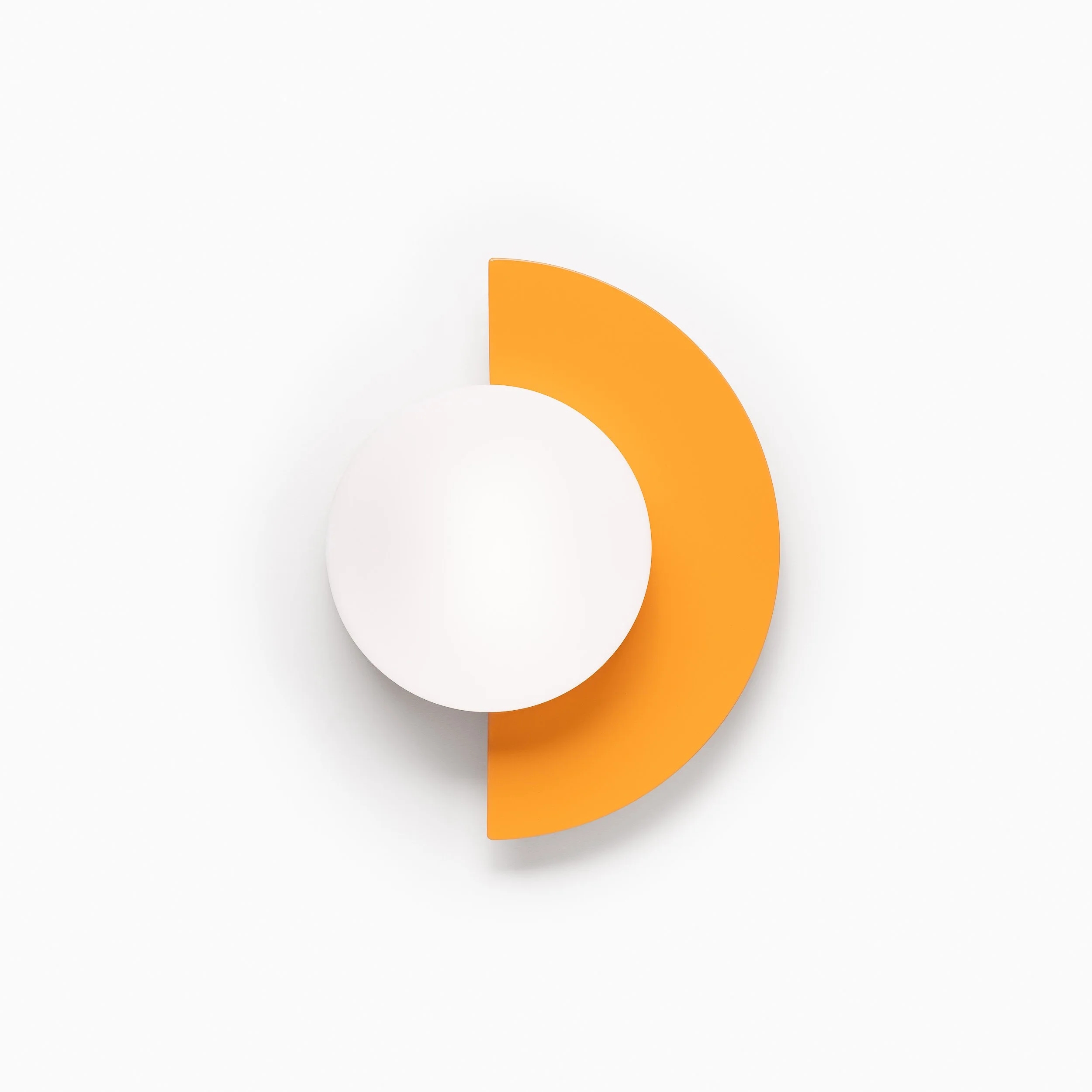 Close-up of a white surface with a semi-circular orange shape overlapping a white circle, resembling a minimalistic sun or abstract design.