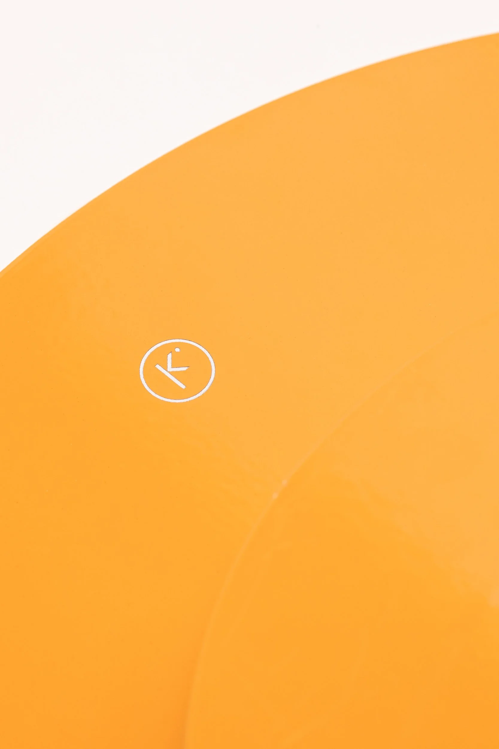 Close-up of a yellow and white object with a small white clock icon on the yellow part.