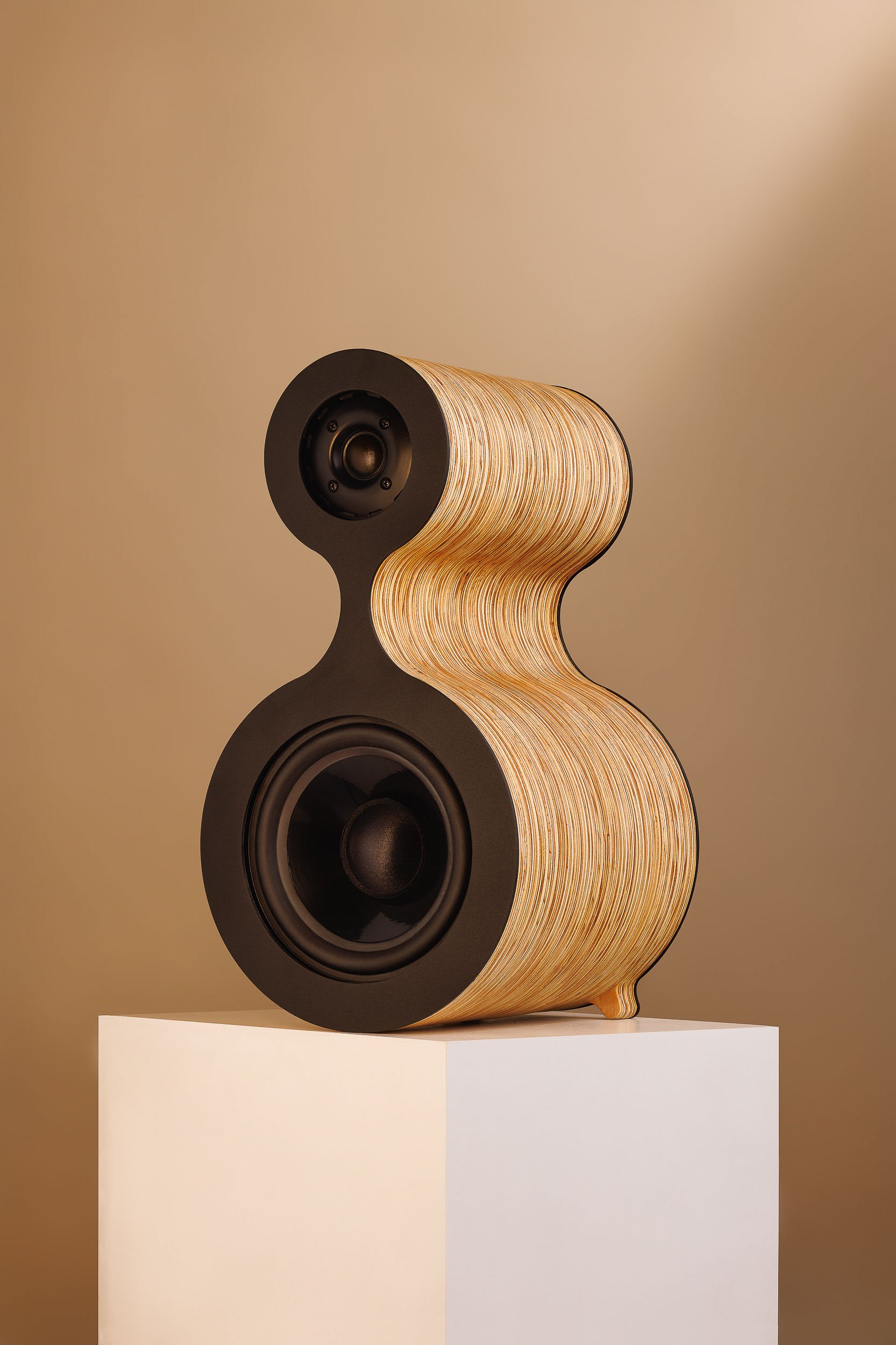 Fourier Acoustics Calabash desktop speaker with sculpted laminated wood body and dual black drivers on white plinth