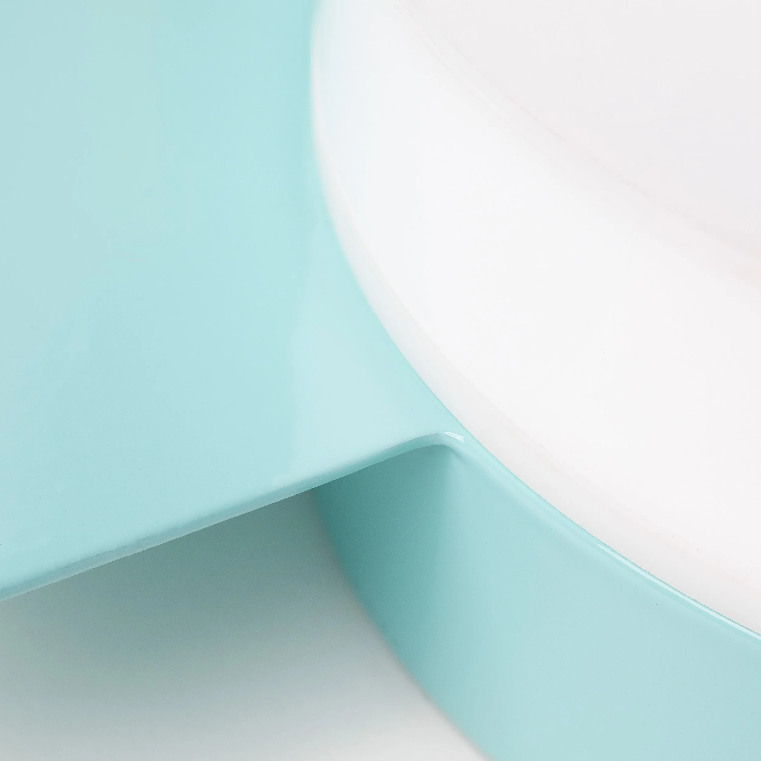 Close-up of a white and light blue geometric structure with curved surfaces.