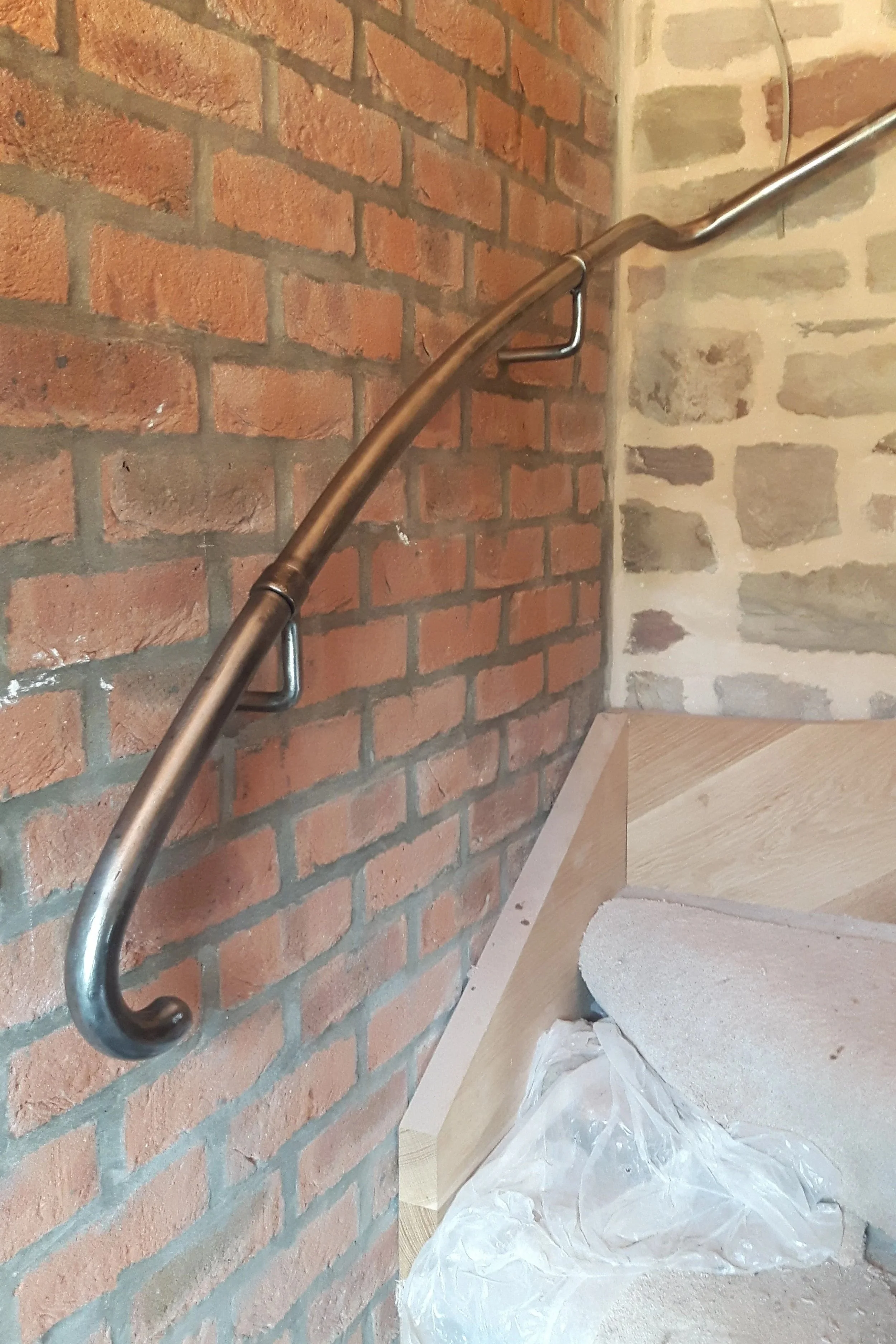 Hand made custom shaped handrail to fit a character staircase.