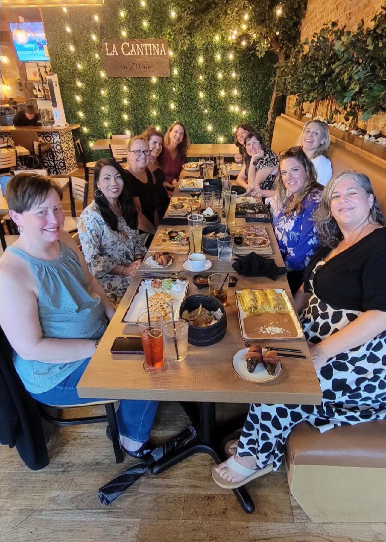 Four adult women standing together outdoors