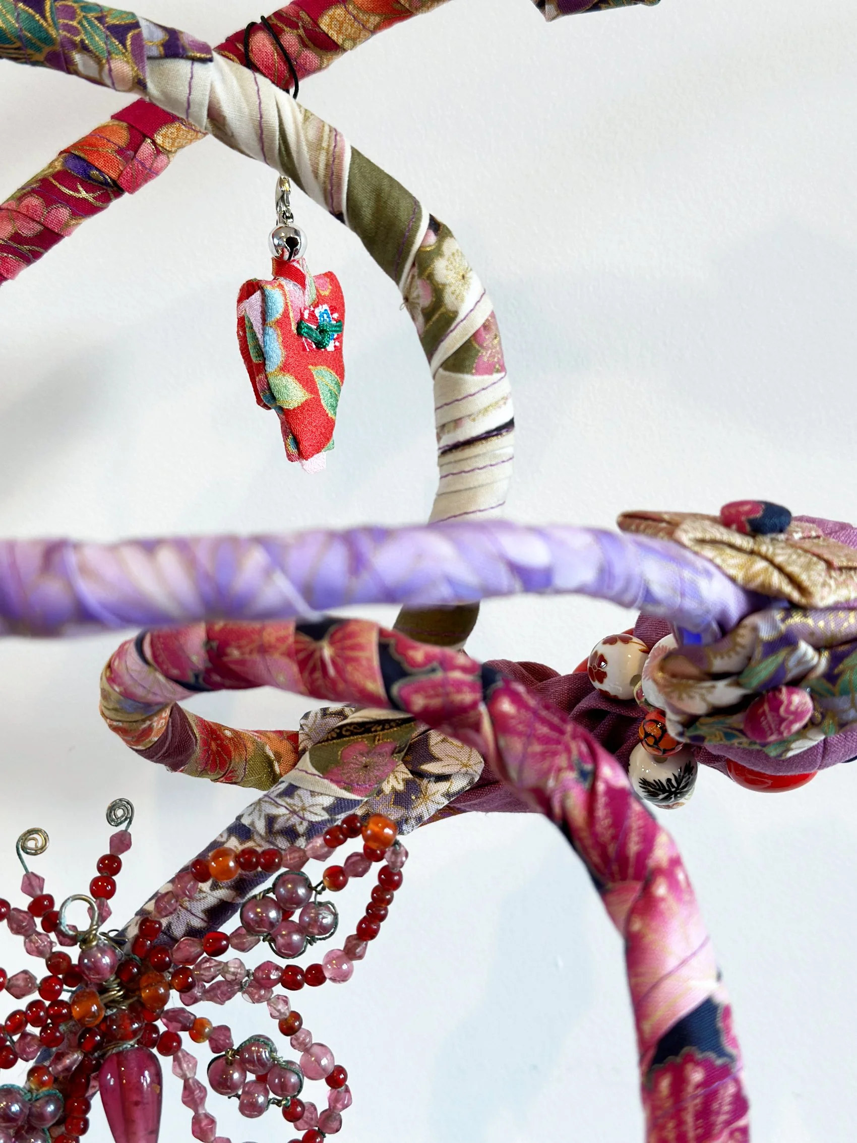 Japanese Garden (Spring), textile sculpture in spring blossom colours showing detail of abstract curves.
