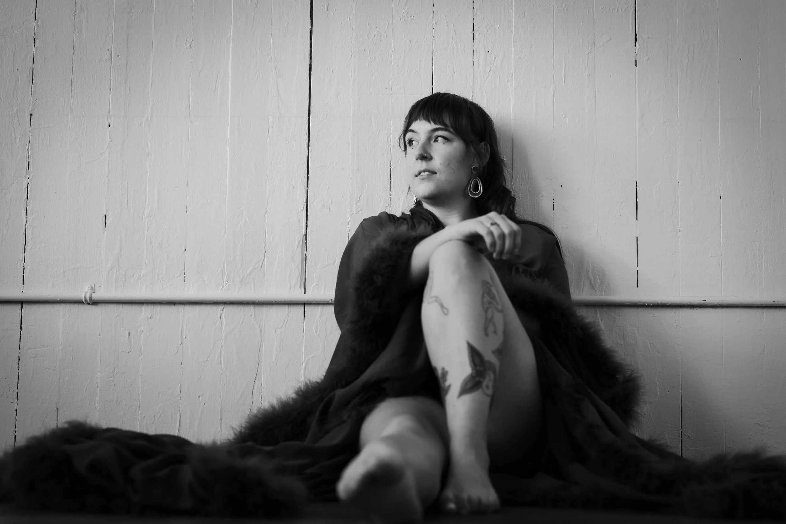 black and white portrait of woman wearing robe with feathers