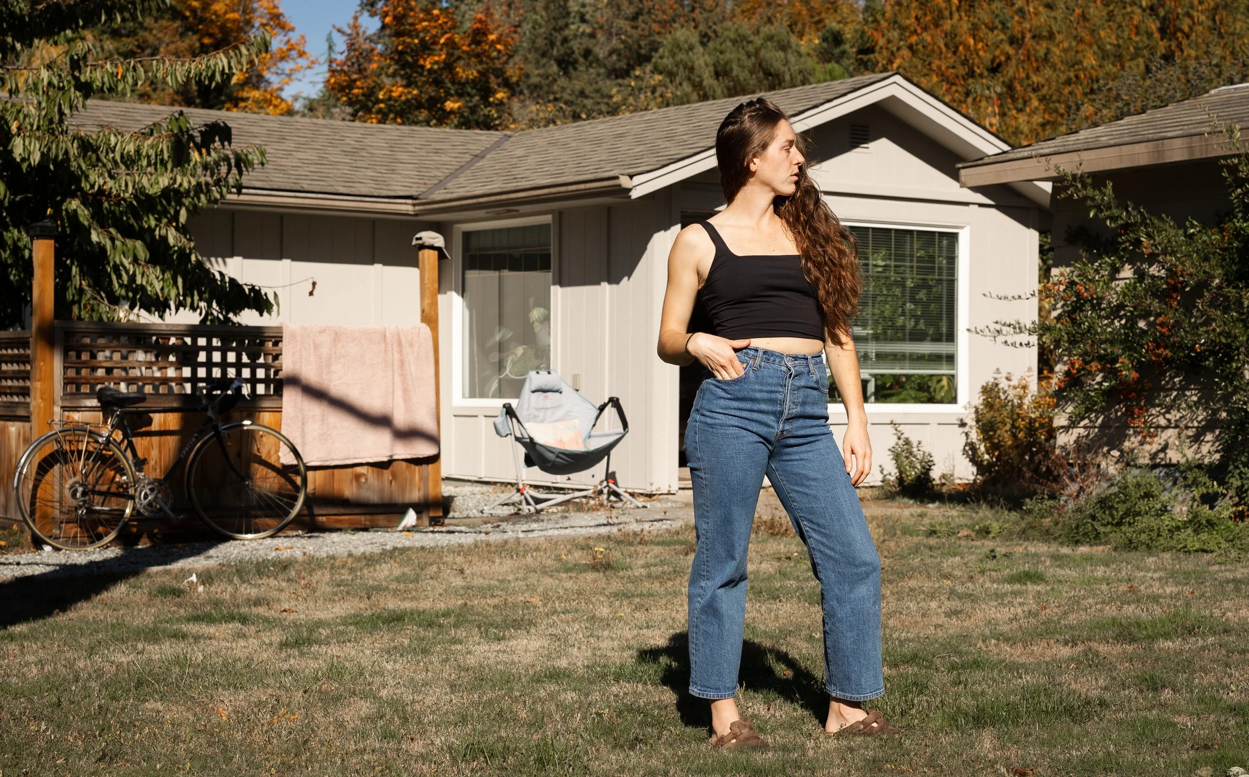 portrait of brunette in front of country cottage