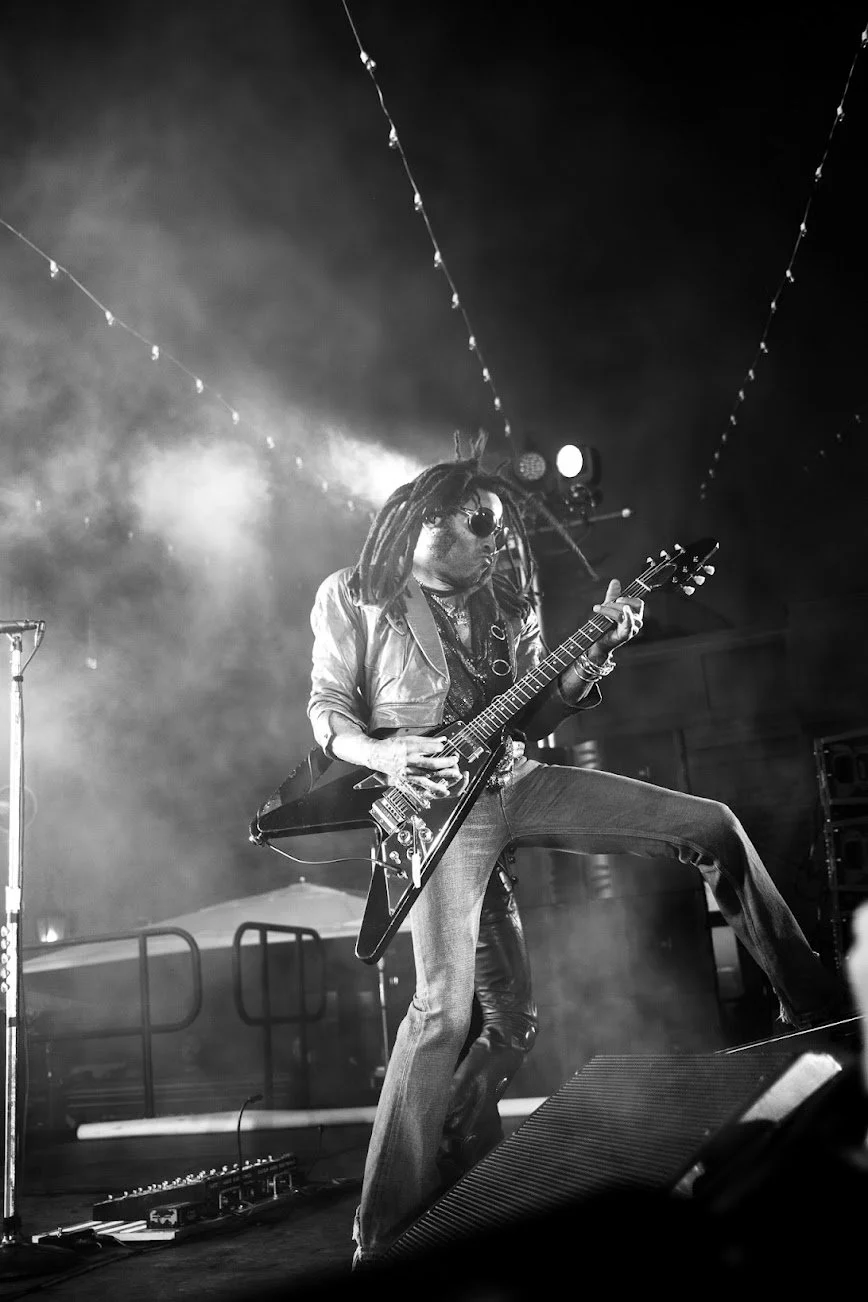 A guitarist performing onstage at The Snow Lodge