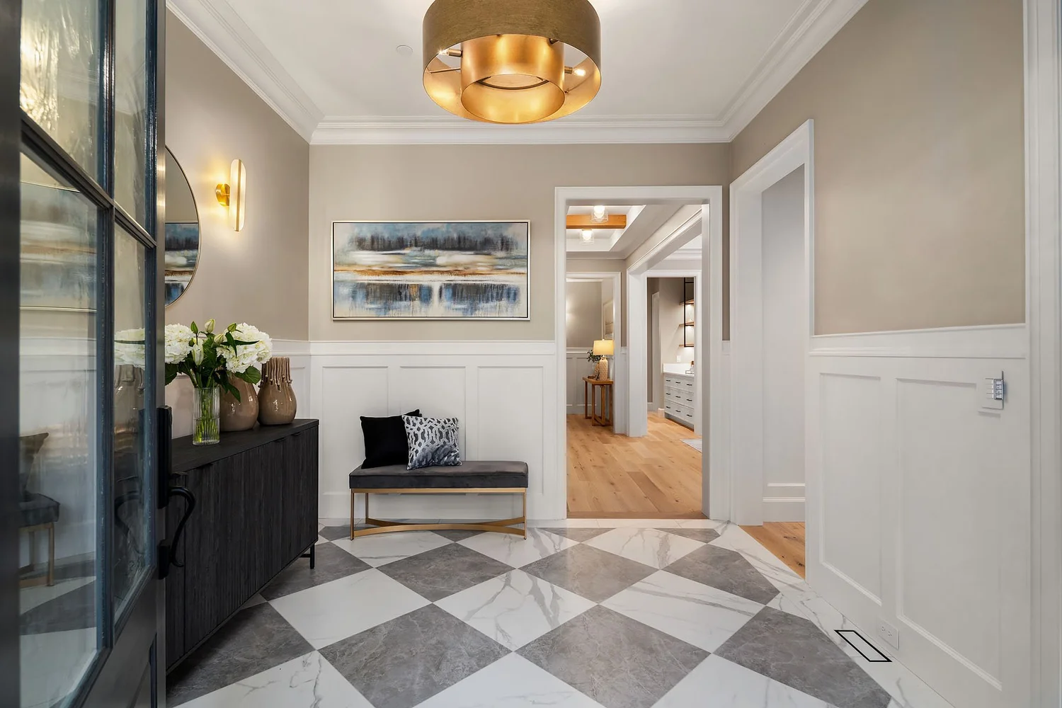 Entry hall with wood flooring, a console table, and pendant lighting