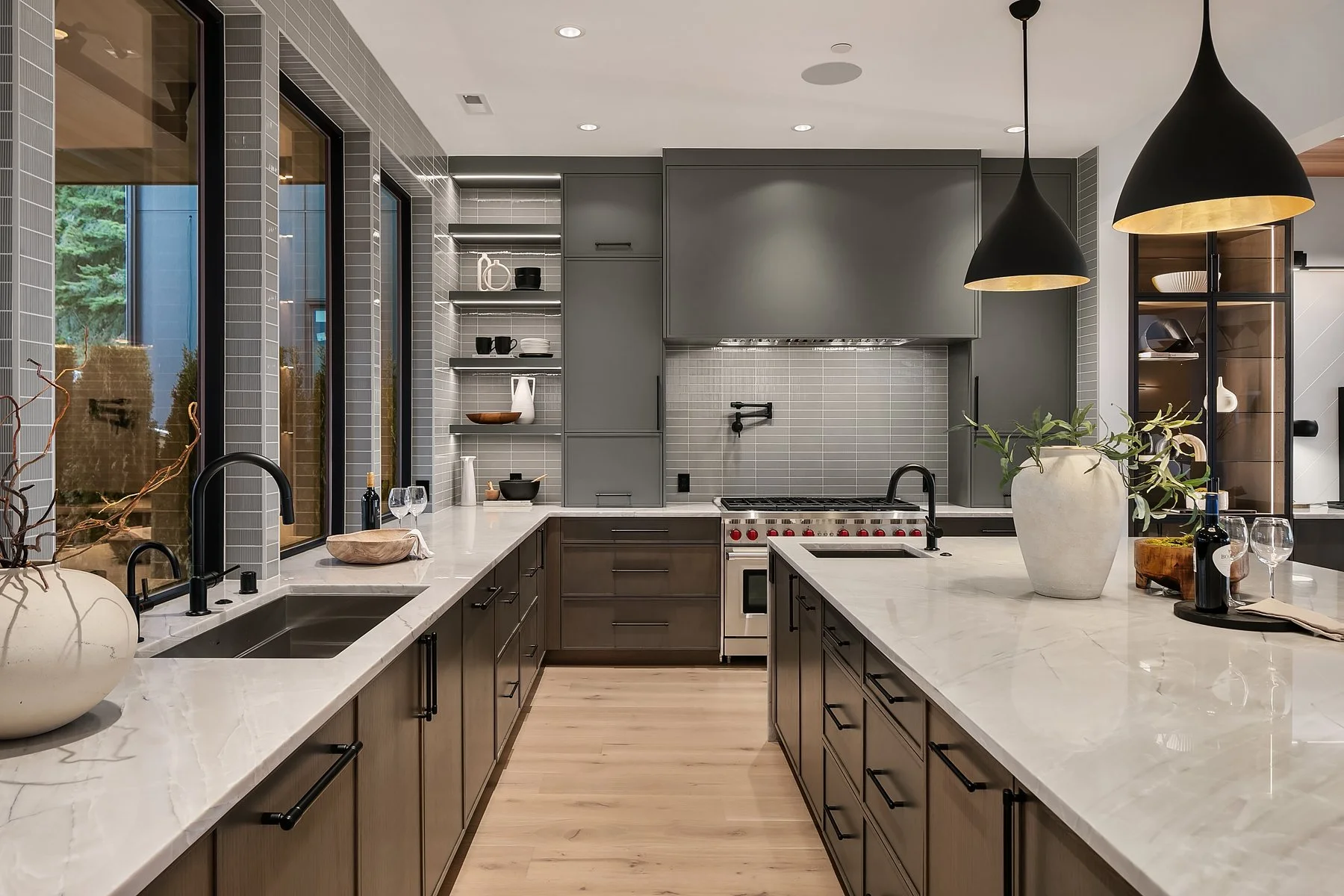 Kitchen with gray cabinetry, white countertops, pendant lighting, and wood flooring