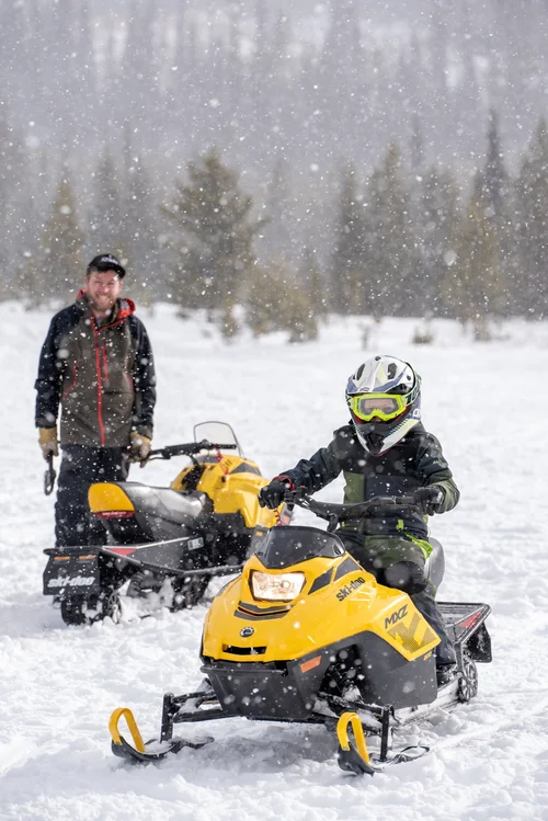 Family snowmobiling in Kamloops, British Columbia