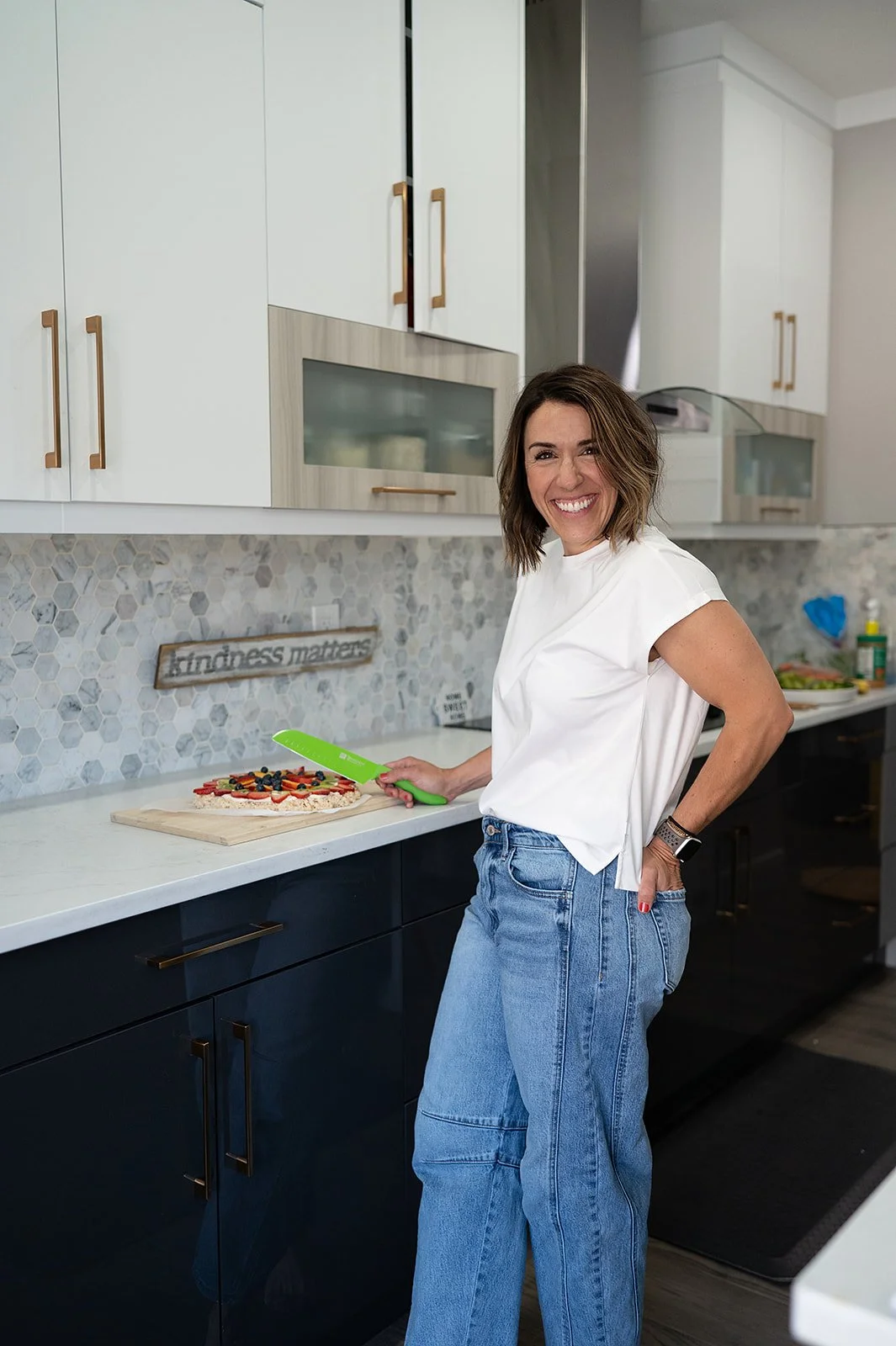 Registered dietitian in Edmonton smiling confidently in her modern kitchen.