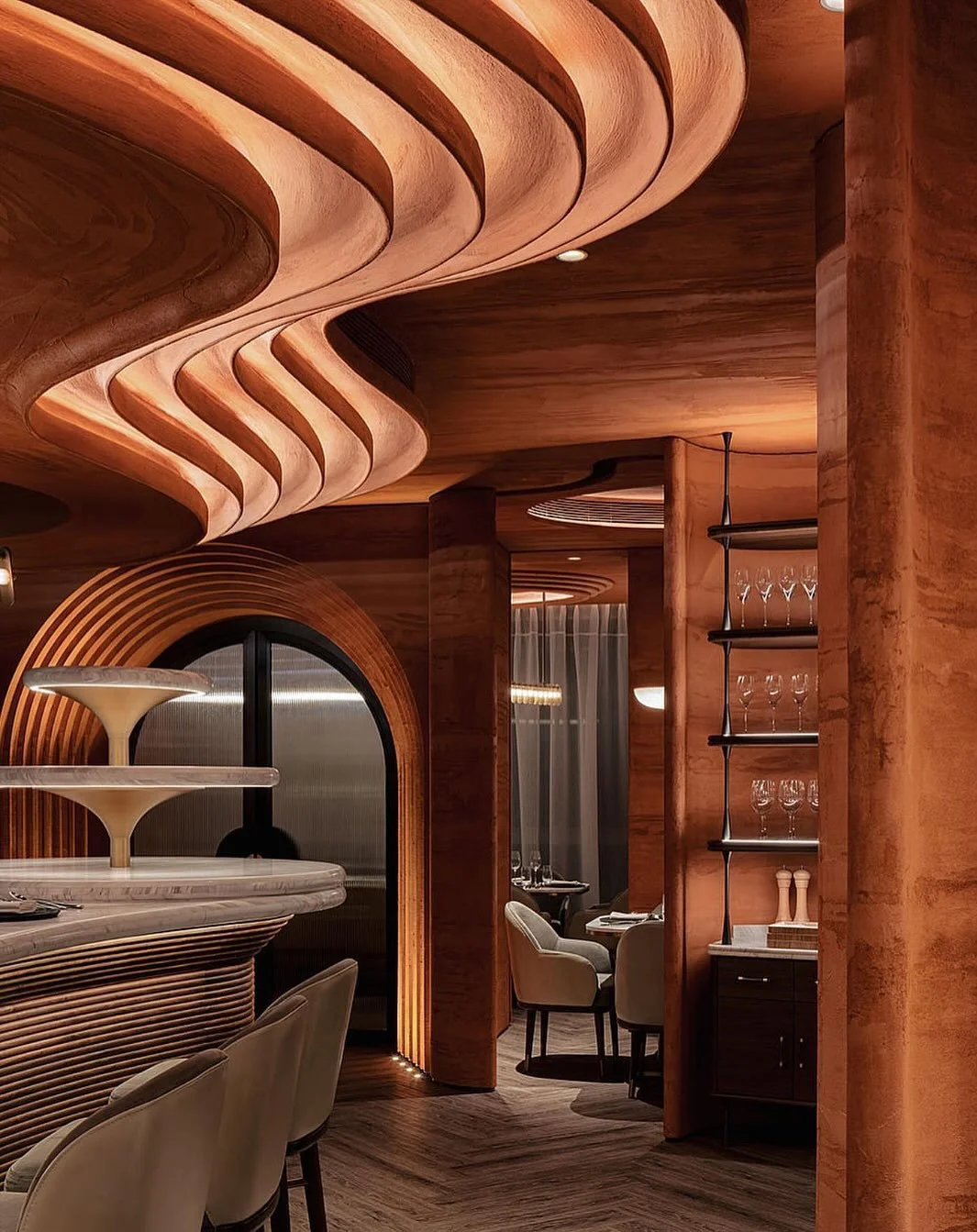 A space where architecture and cuisine speak the same language.
At 1111 ONES, every curve, surface, and shadow evokes the sculptural grace of nature &mdash; carved in terracotta hues, wrapped in rhythm, and softened by light.

From the undulating cei