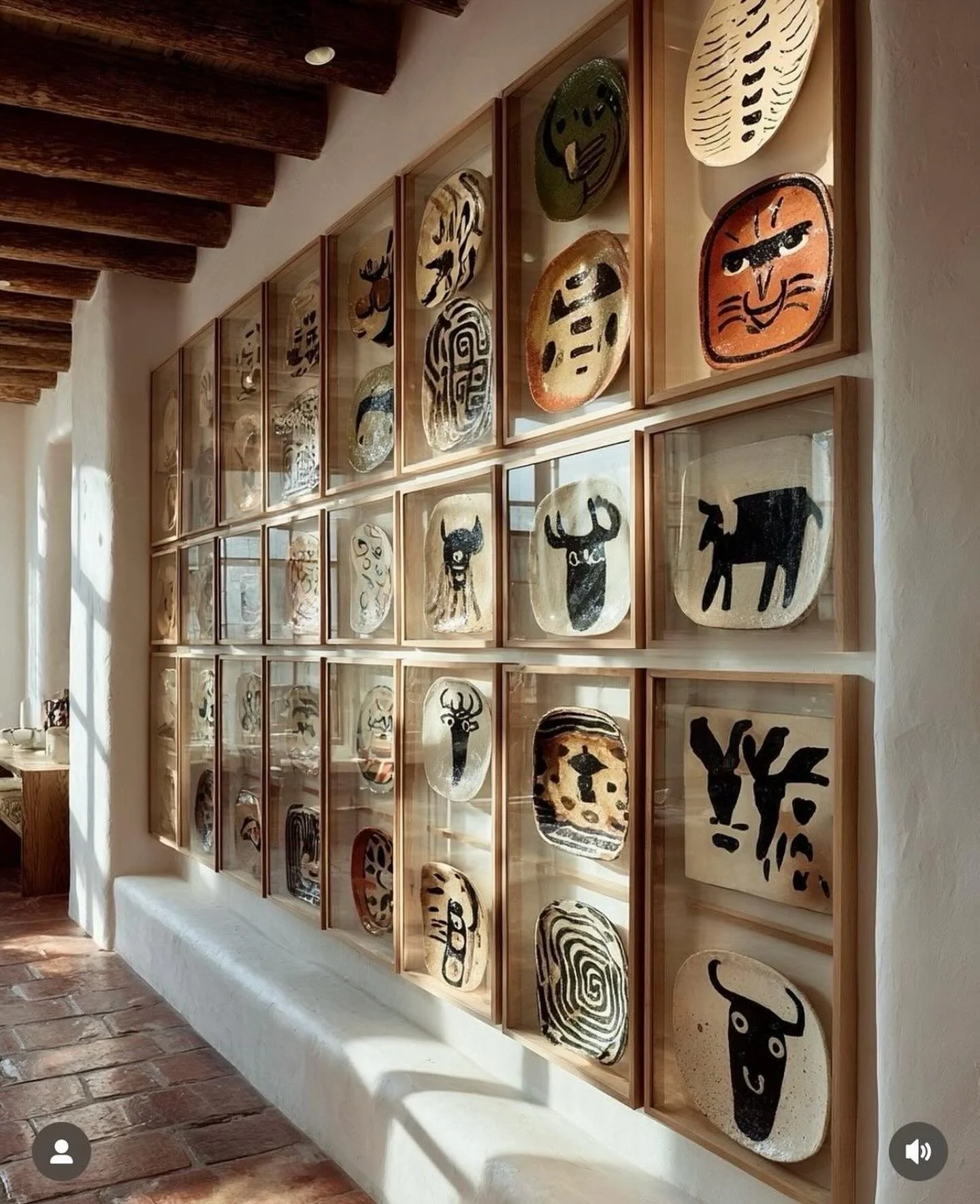 Turning everyday objects into curated art is one of my favorite ways to make a space feel intentional, storied, and alive.

This wall of hand-painted plates, each framed like a treasure, transforms a corridor into a gallery moment. The repetition of 