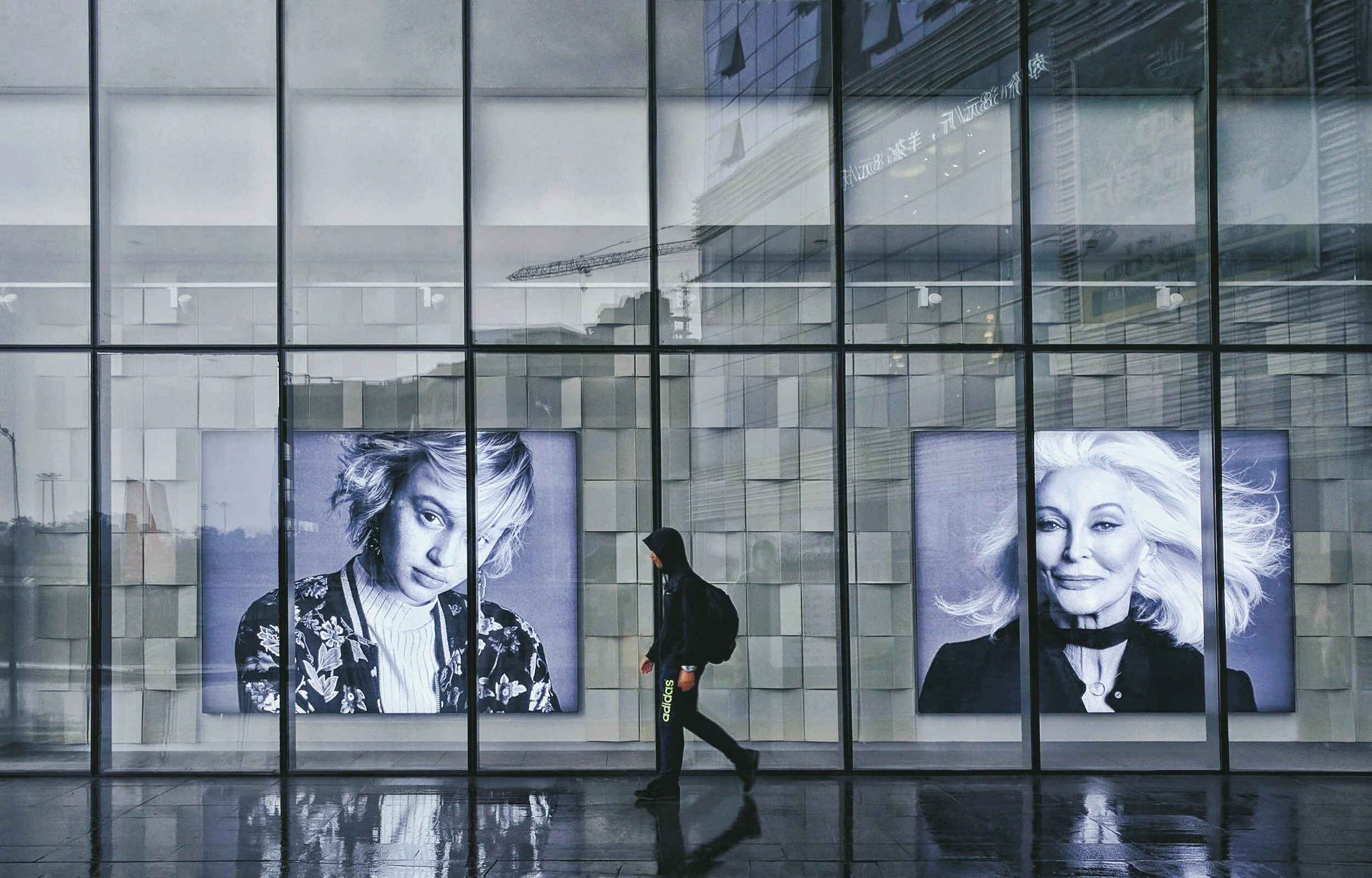 man walking by digital advertising