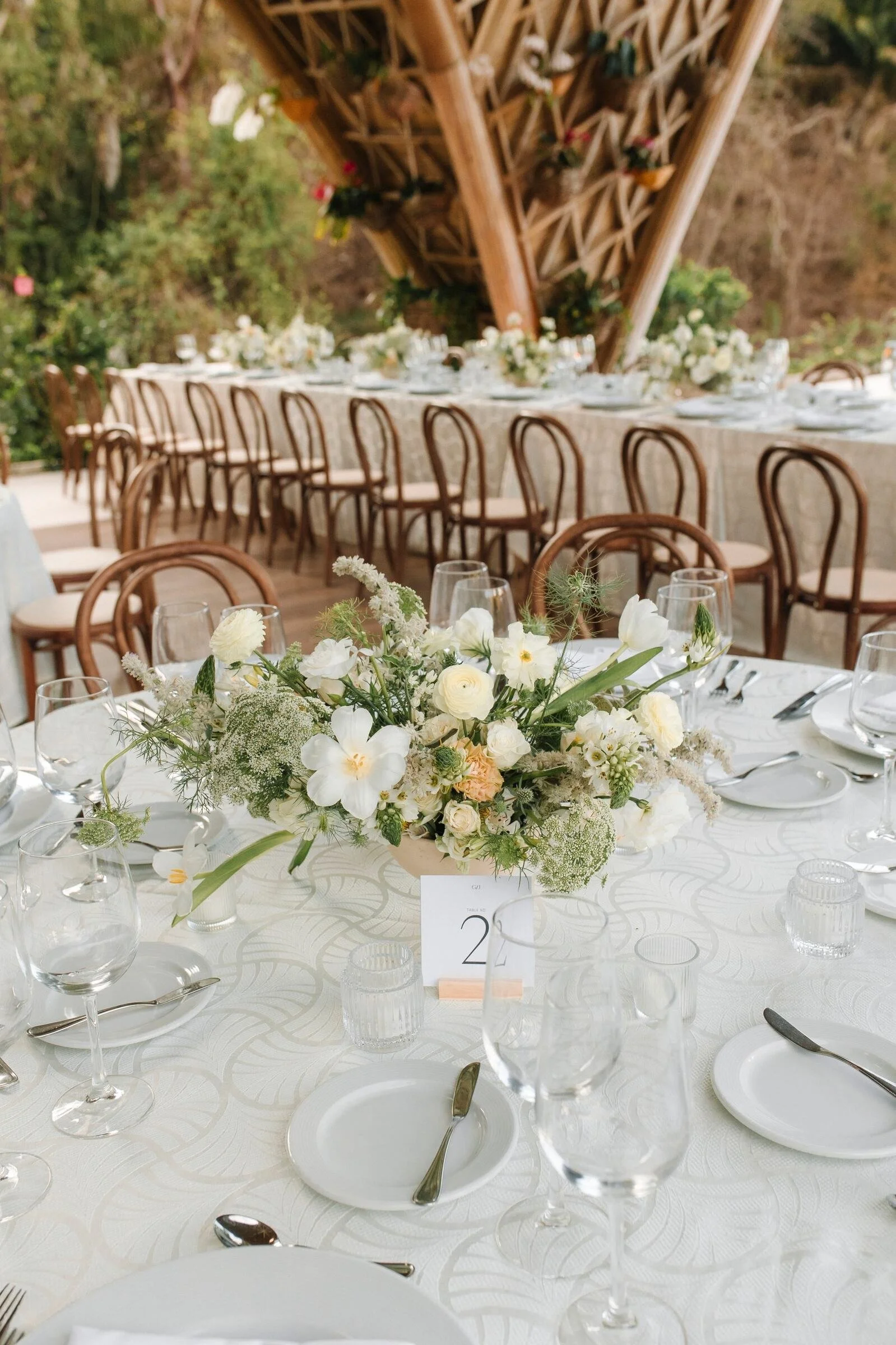 Round table with a low white and cream centerpiece at Garza Blanca The Forum