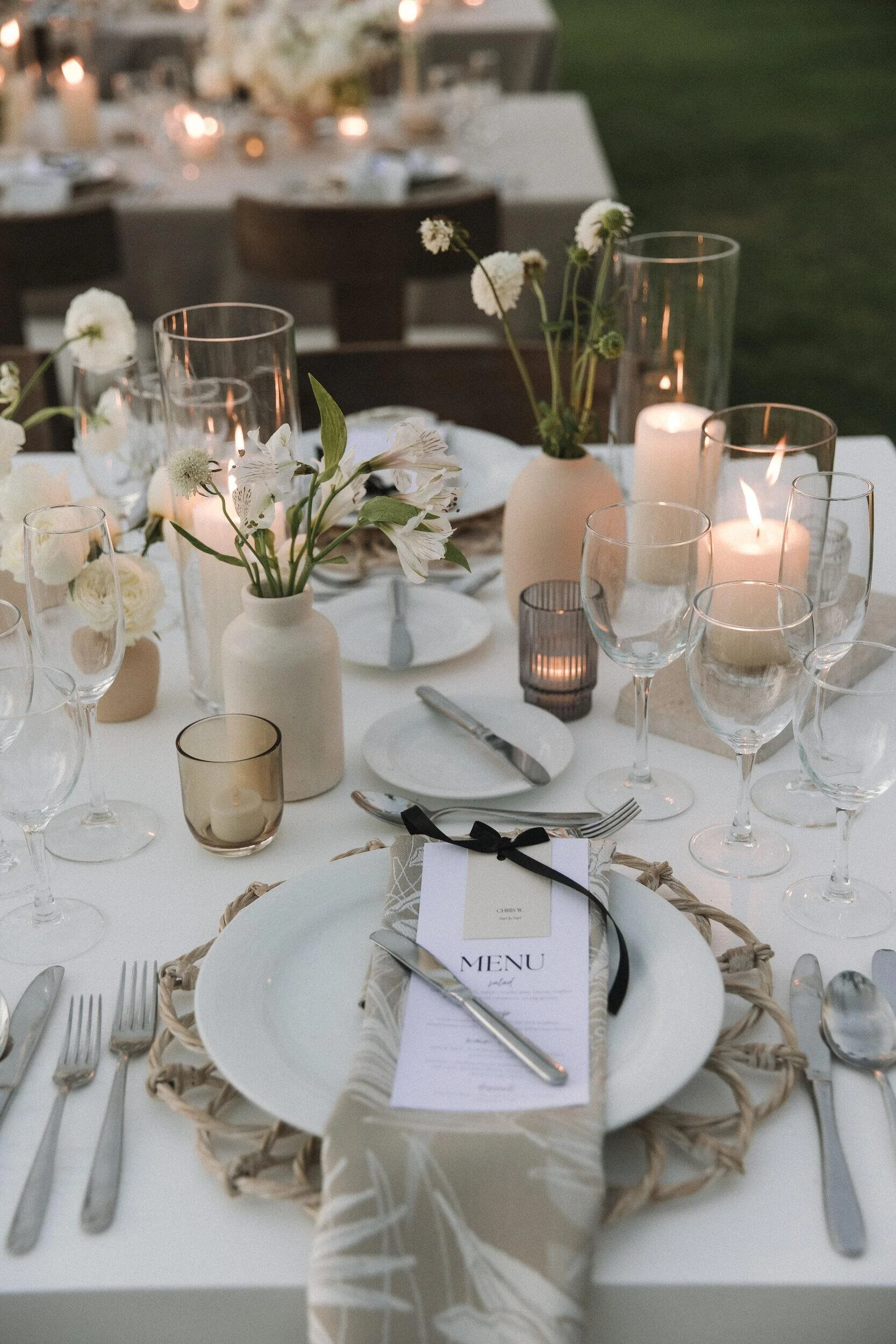 Place setting with white florals and menu at Grand Velas Riviera Nayarit