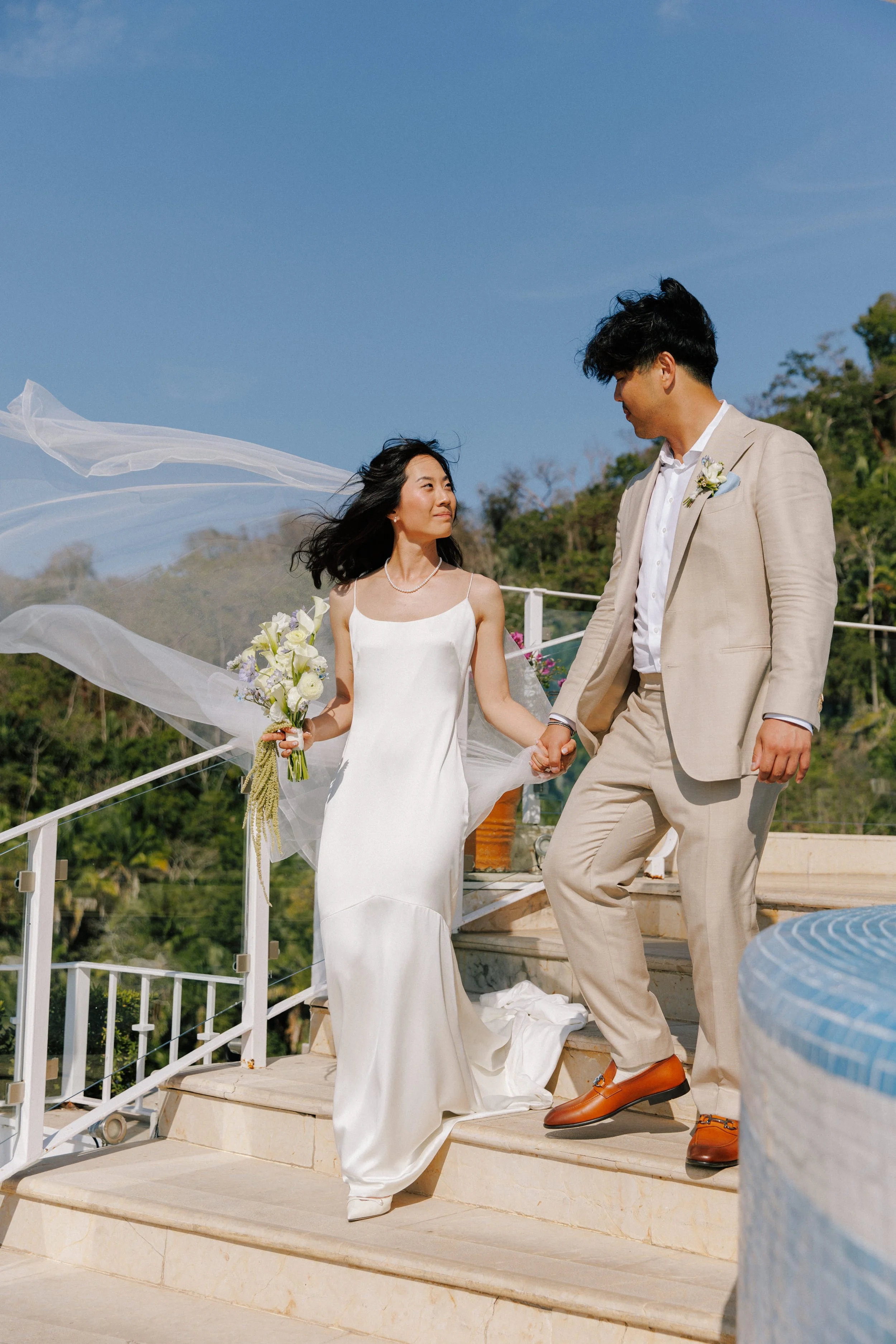 Bride and groom first look on the terrace as the veil catches the wind, Puerto Vallarta