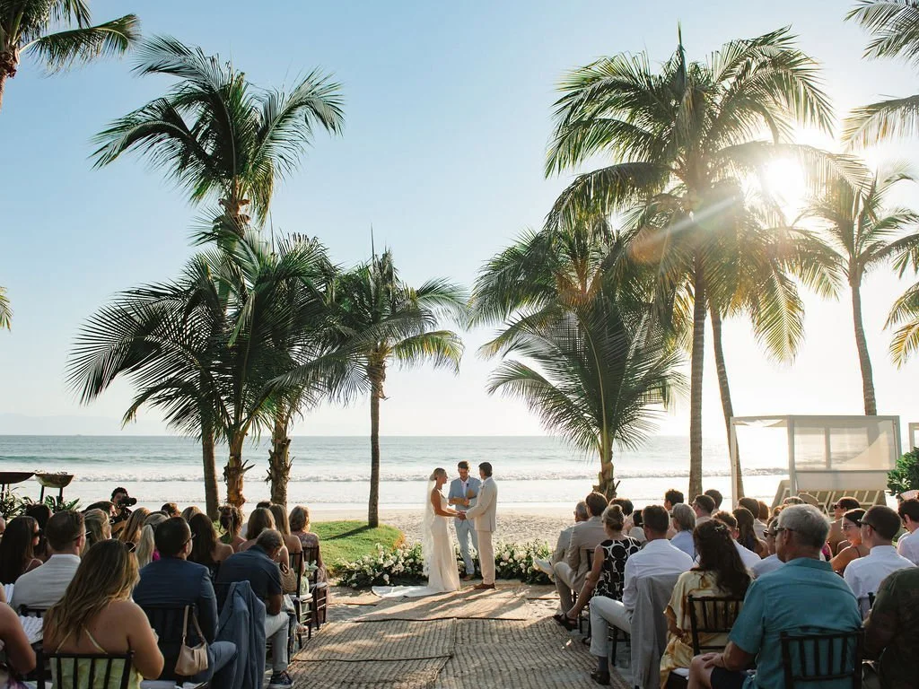 Wedding ceremony framed by palm trees facing the ocean at W Punta de Mita (Copy)