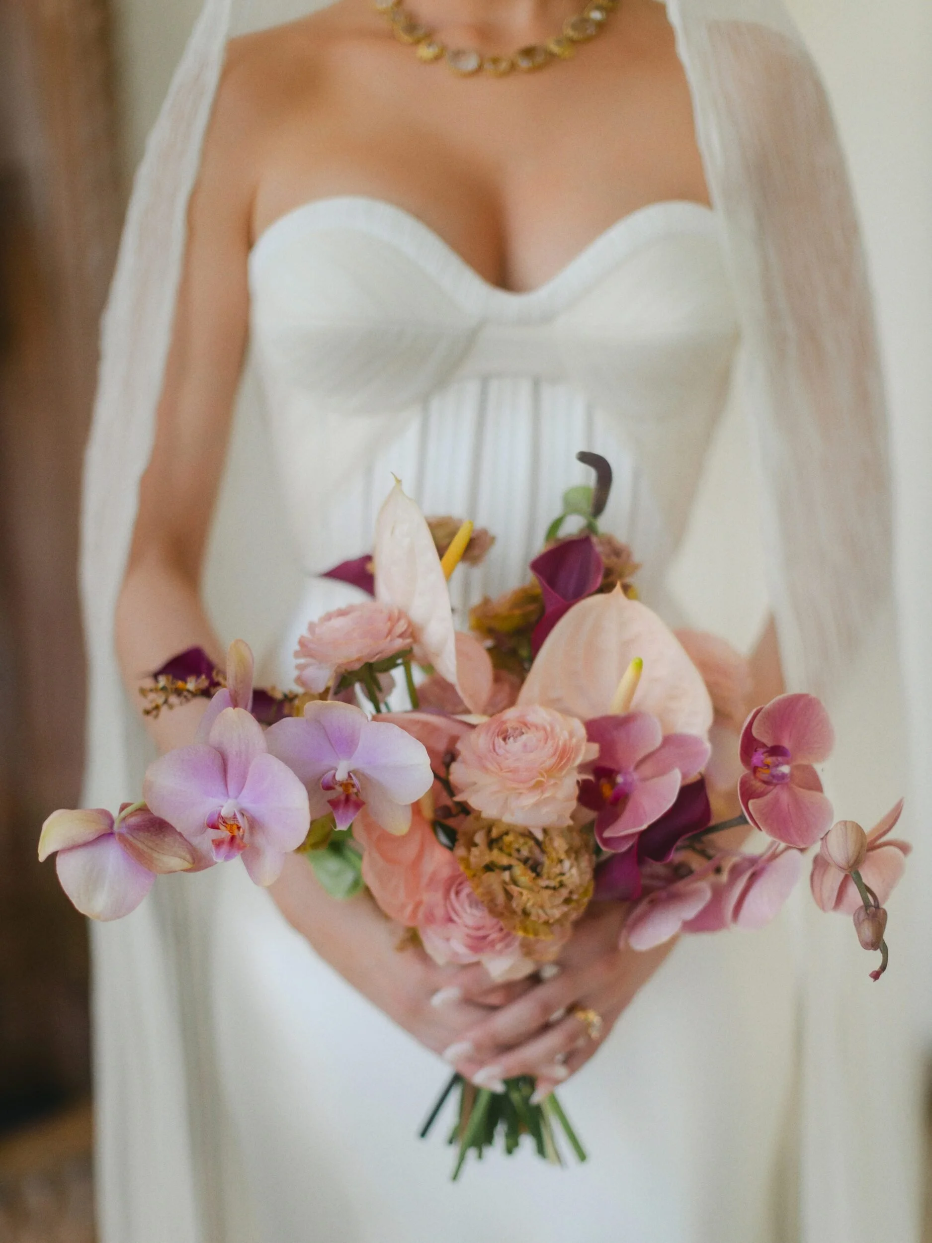 Bride holding a blush and mauve orchid bouquet at Casa Kimberly, Puerto Vallarta