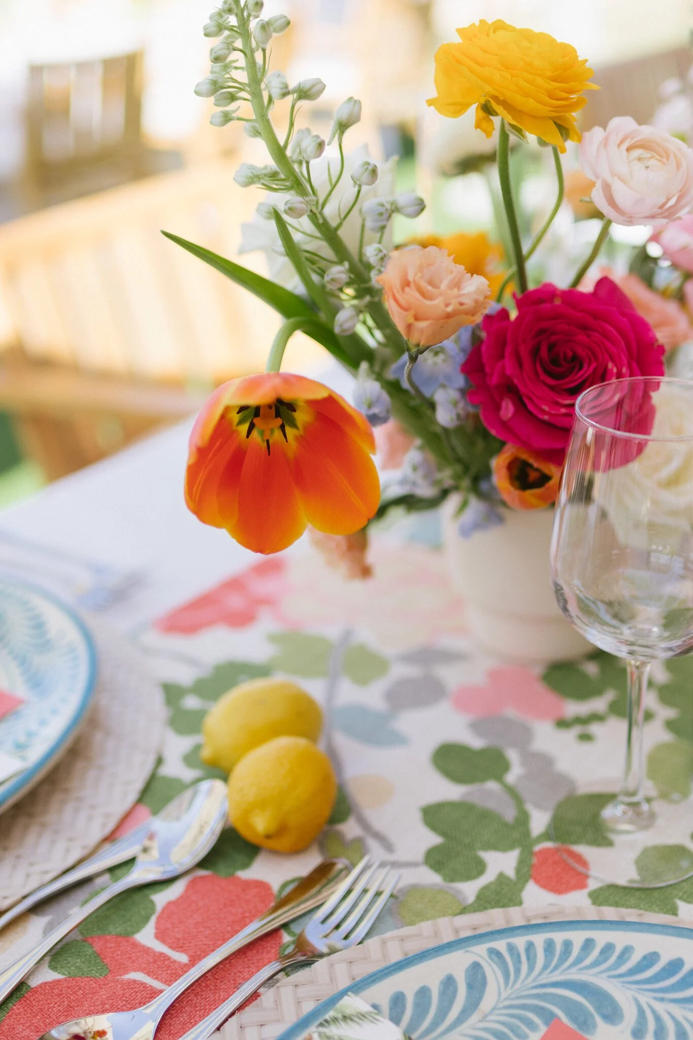 Welcome party place setting with lemons and bright florals at Four Seasons Punta Mita