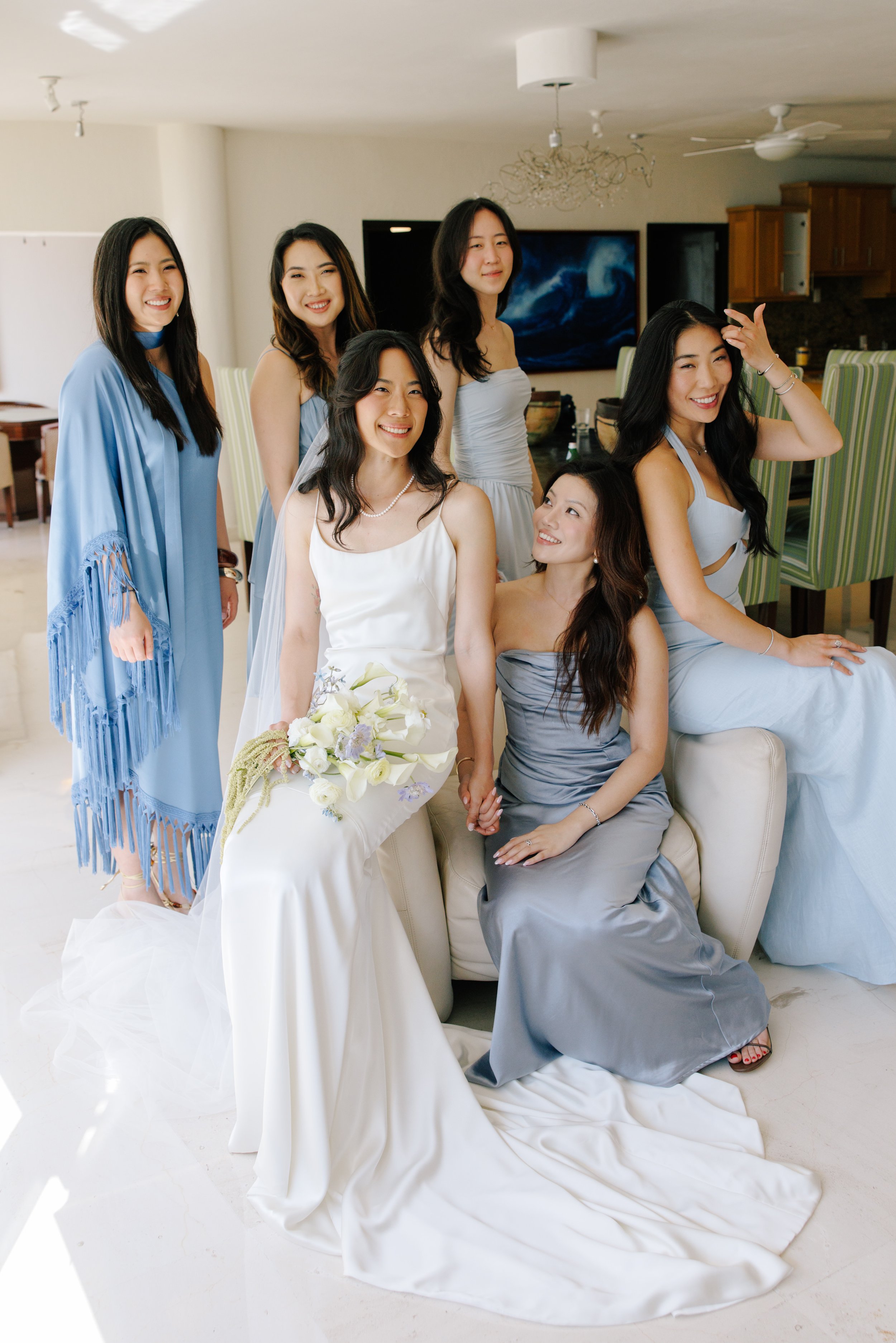 Bridesmaids in dusty-blue dresses at a Grand Miramar destination wedding