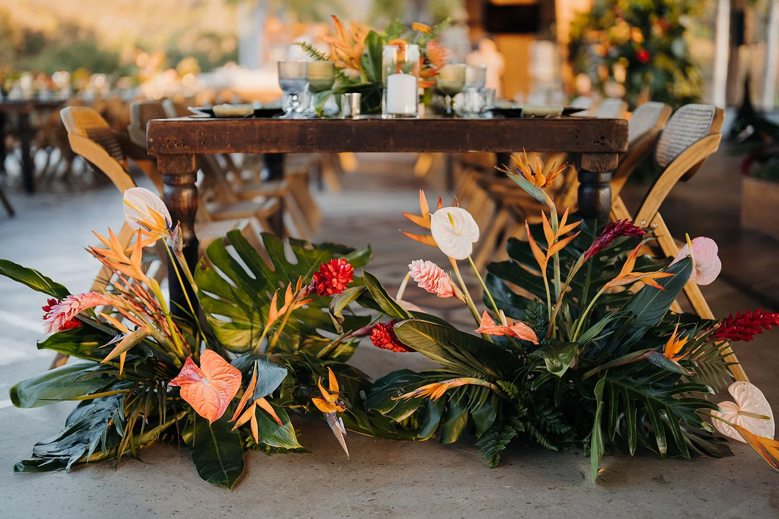 Head table with bird of paradise and coral anthurium at Tierra Tropical Polo Club