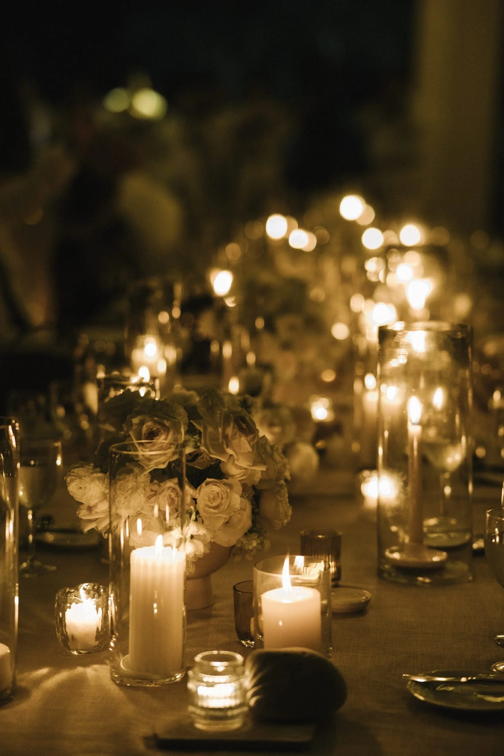 Candlelit table detail with white roses at Grand Velas Riviera Nayarit