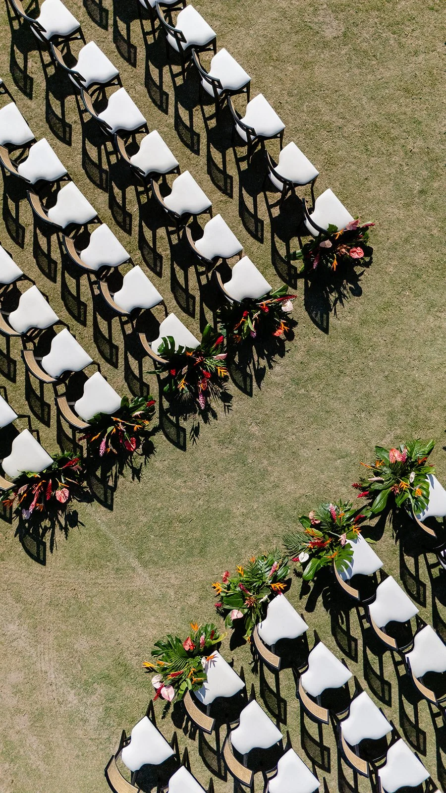 Aerial view of the ceremony chairs and tropical aisle installations at Tierra Tropical Polo Club