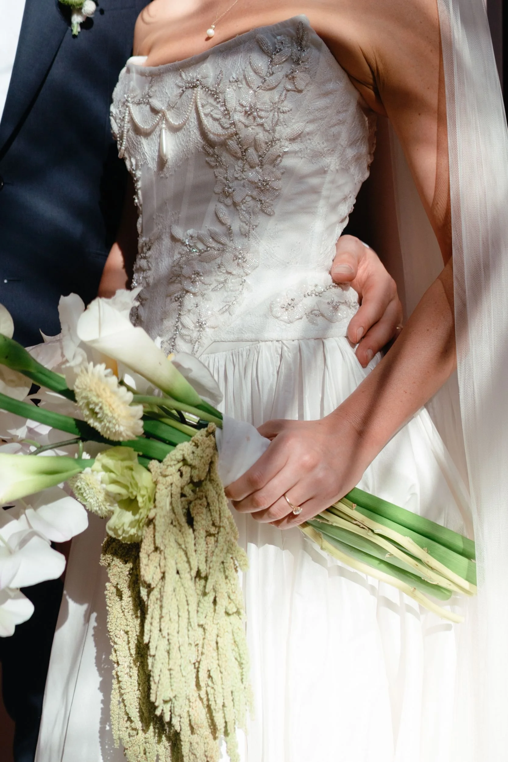 Bridal bouquet of white calla lilies with trailing green amaranthus