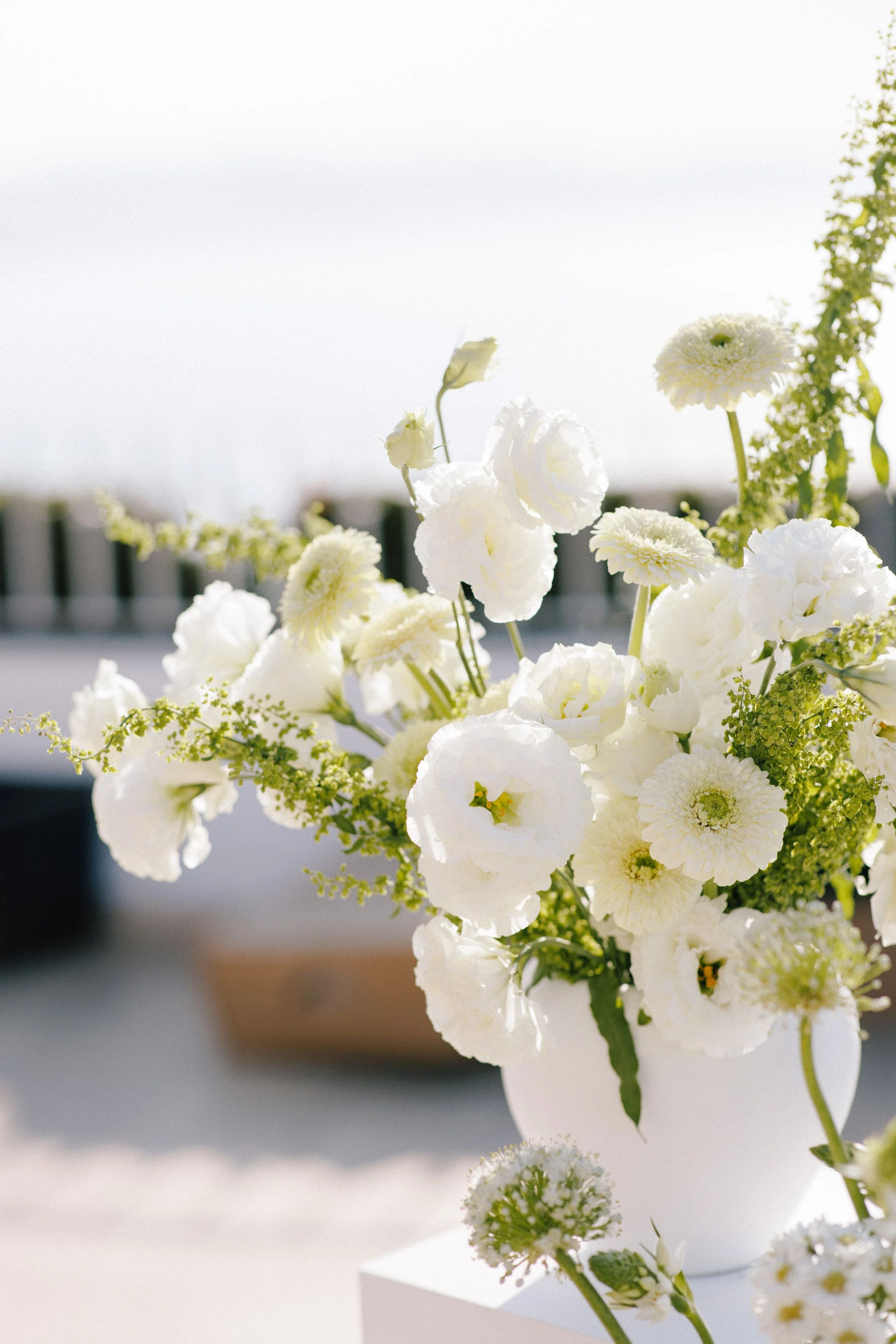White lisianthus and mini gerbera in a ceremony arrangement at Grand Miramar