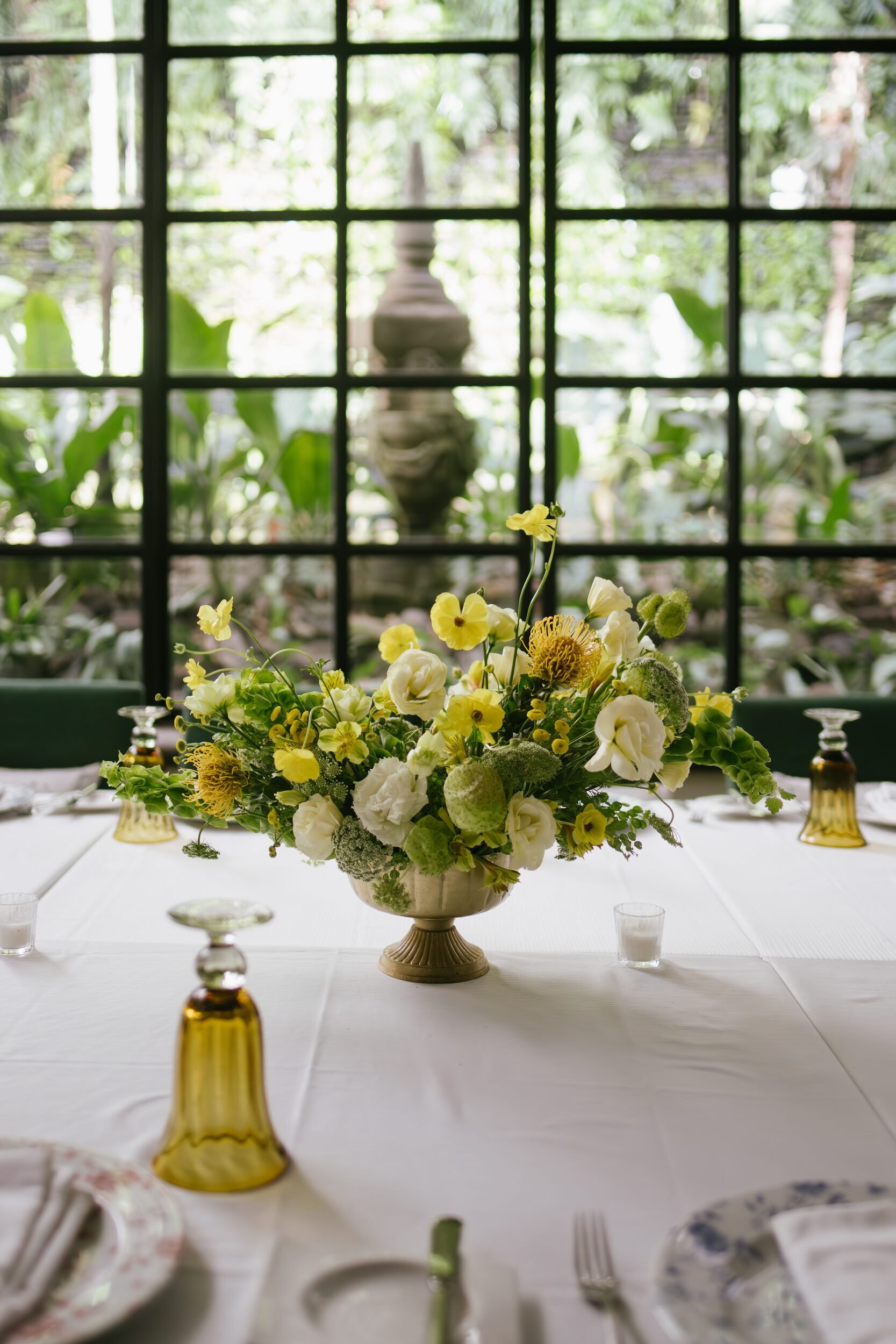 Yellow arrangement with pin cushion, butterfly ranunculus and lisianthus at Café des Artistes, Puerto Vallarta