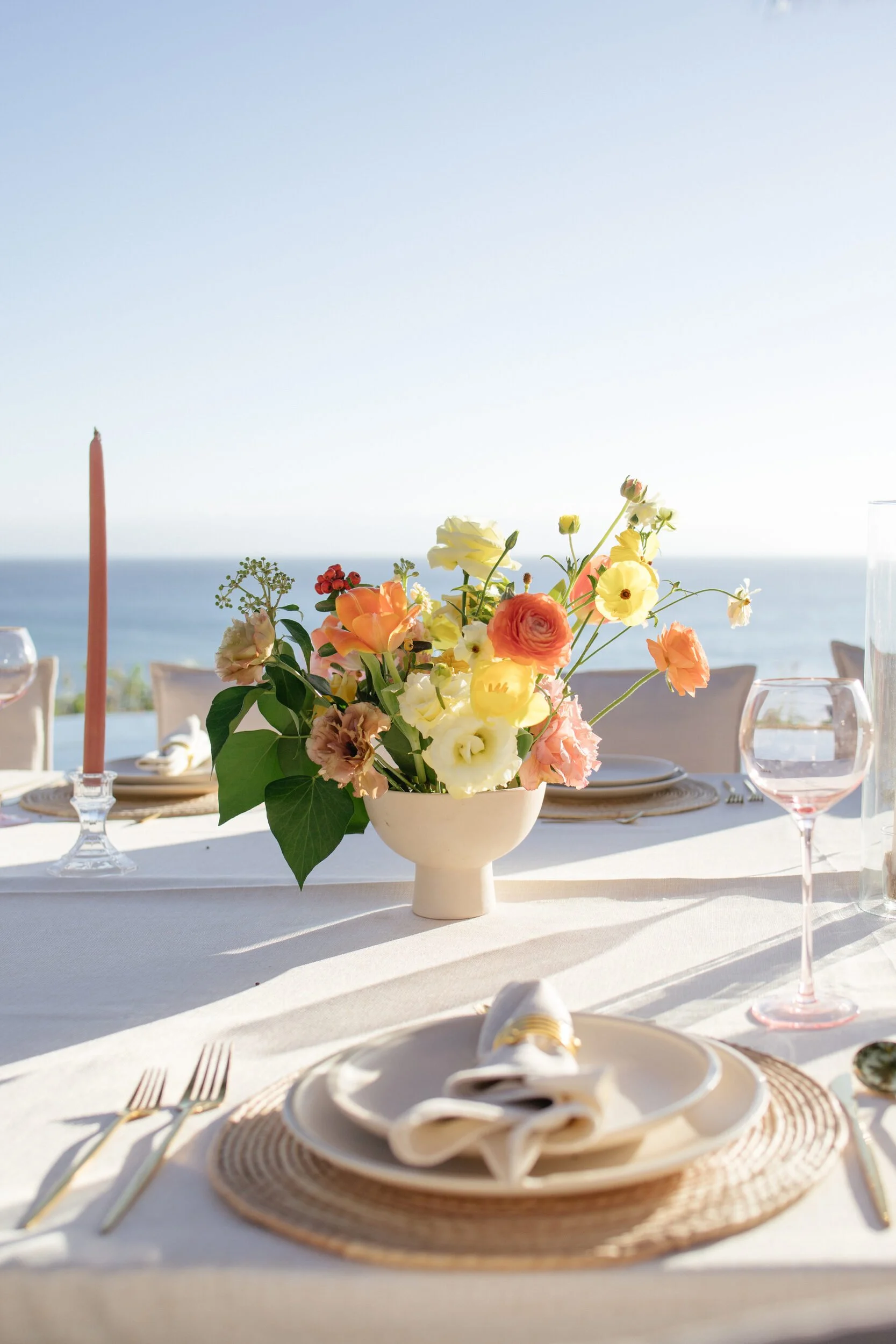 Citrus centerpiece and taper candle with the ocean behind, Punta de Mita