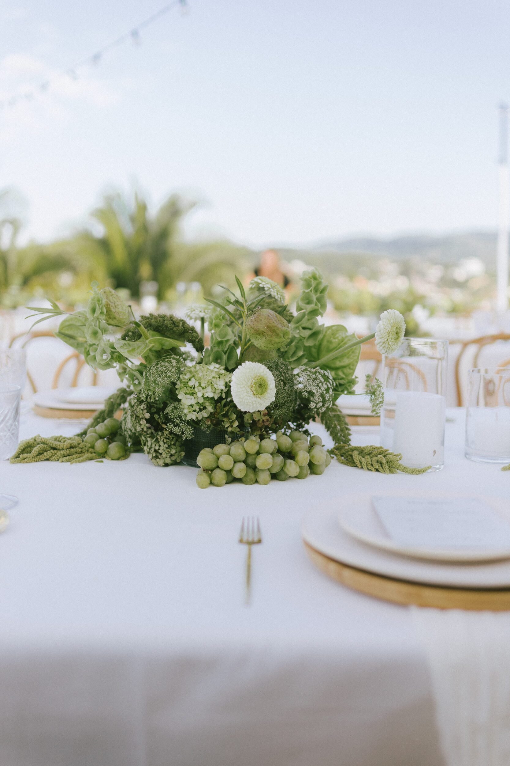 Green and white tablescape with grapes and anthurium at a Sayulita wedding