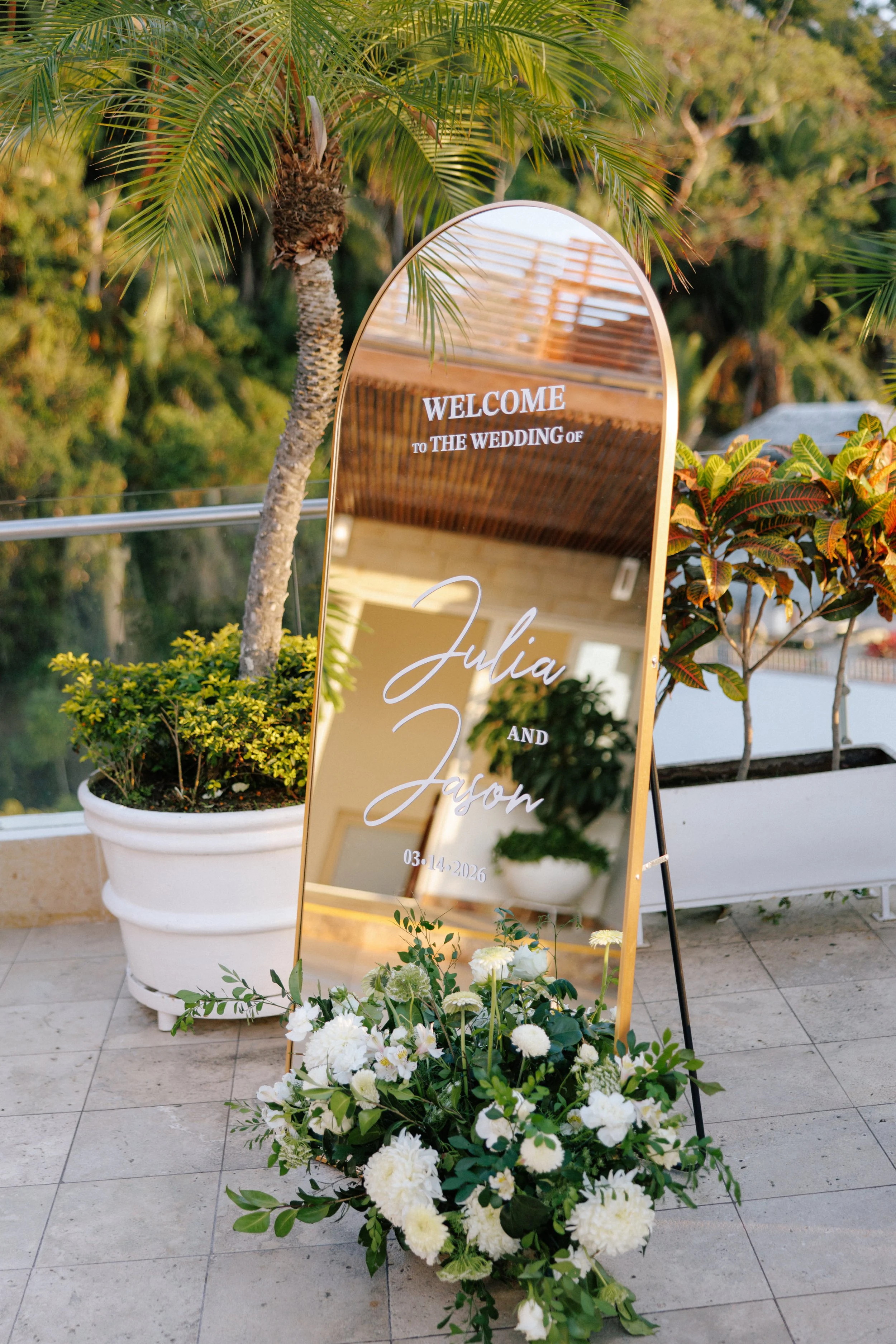 Mirror welcome sign with grounded white florals at Grand Miramar, Puerto Vallarta