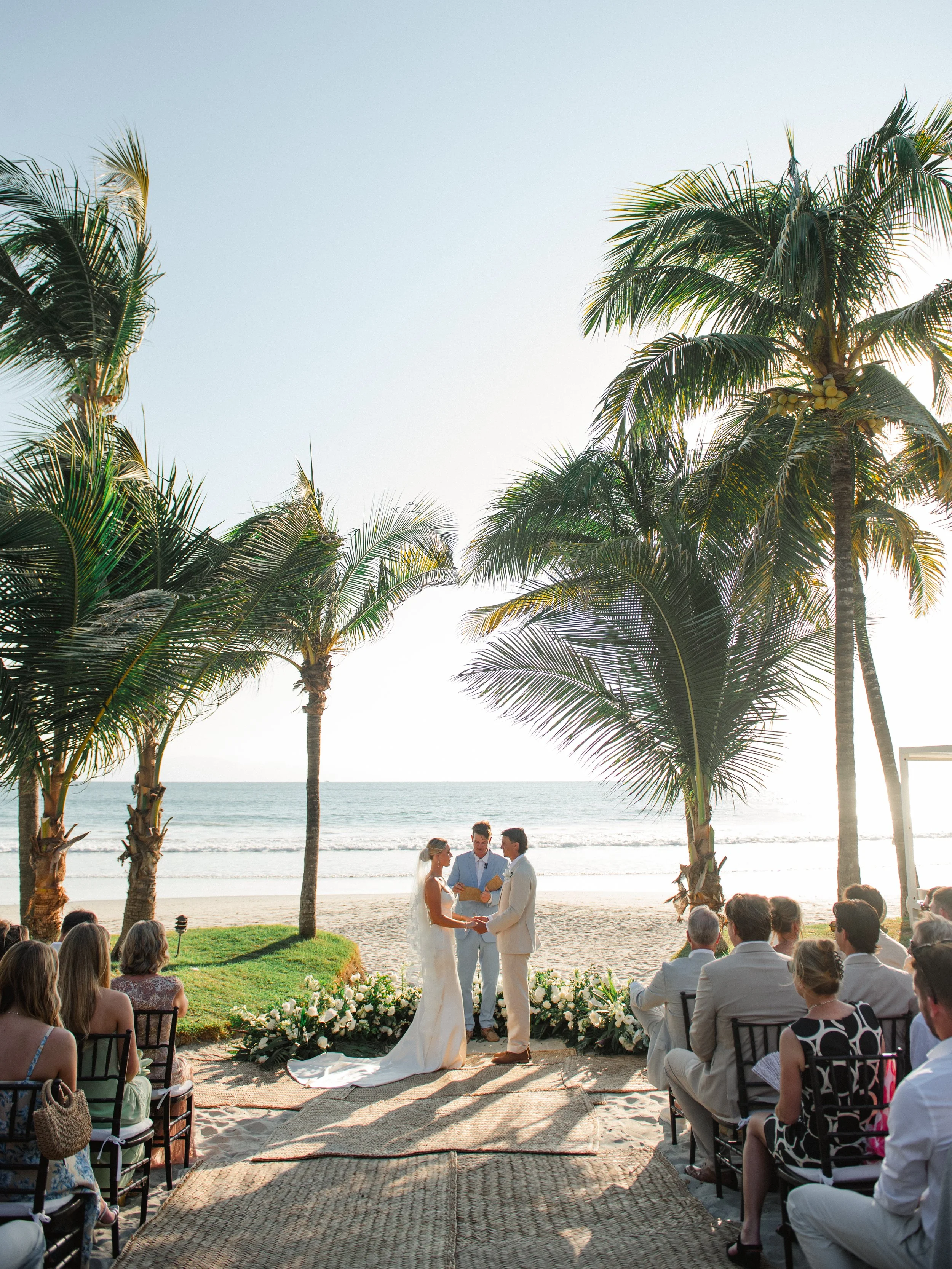 Beachfront ceremony with grounded white florals at W Punta de Mita
