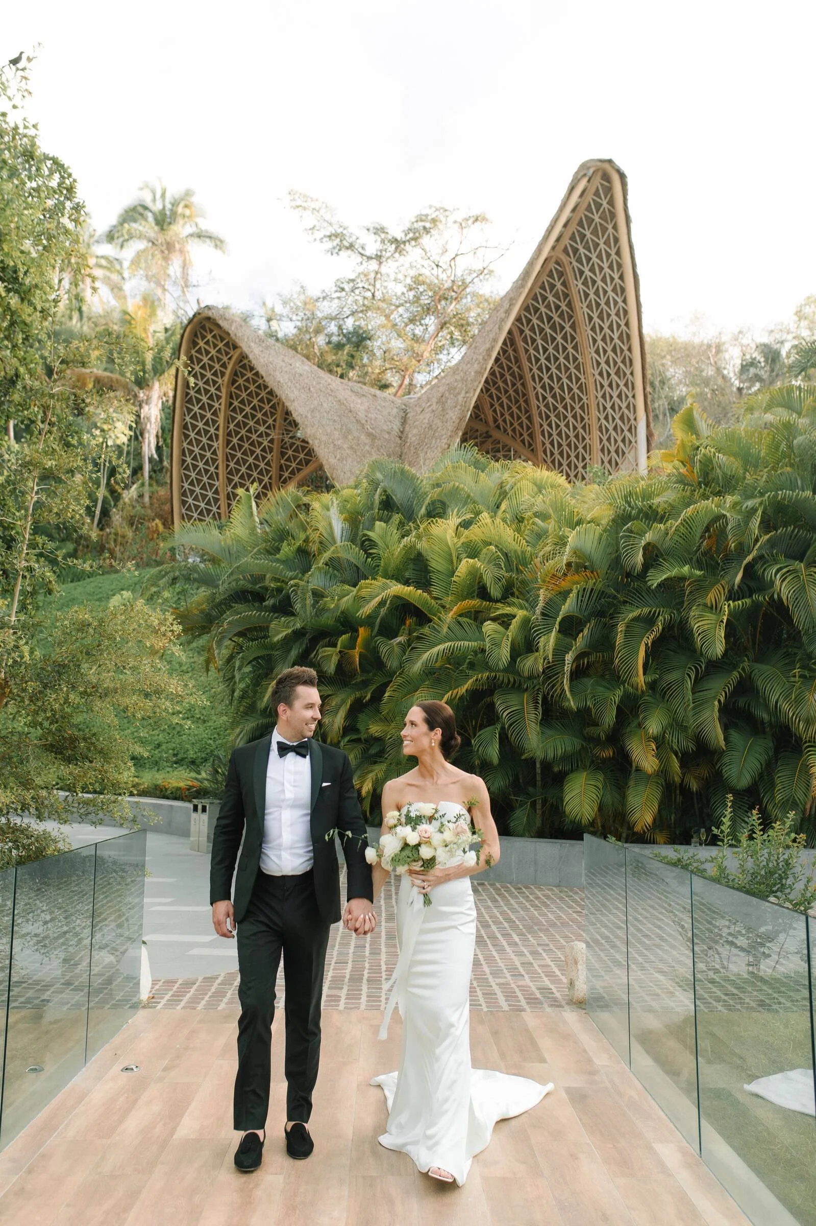 Couple walking below the pavilion at Garza Blanca The Forum