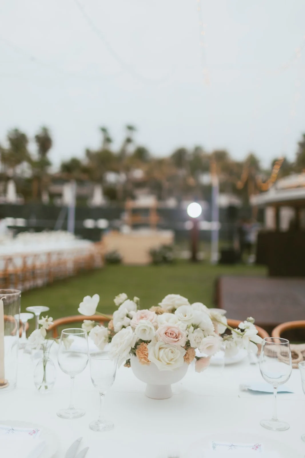 Blush and white centerpiece on a reception table at a Punta Mita wedding