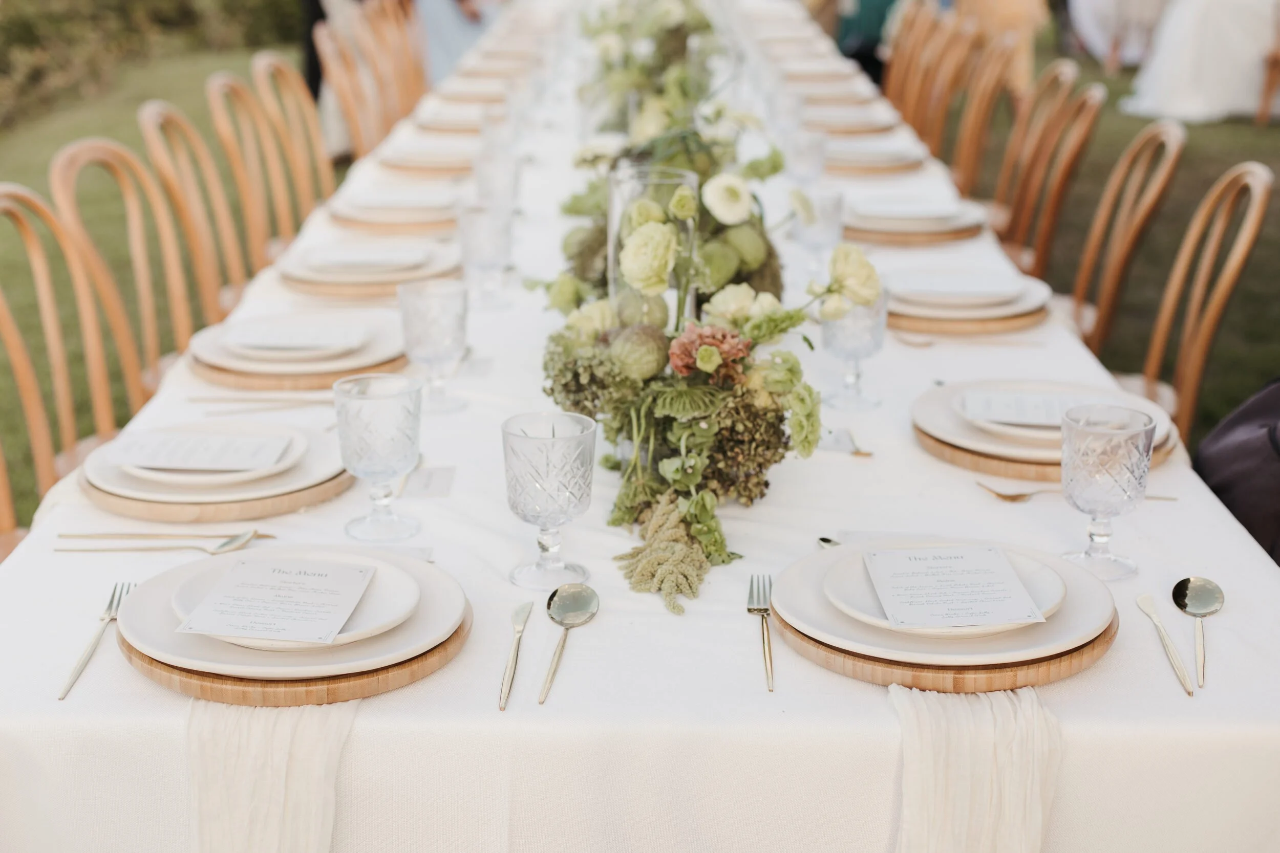 Long table with a green and white floral runner at a Sayulita wedding