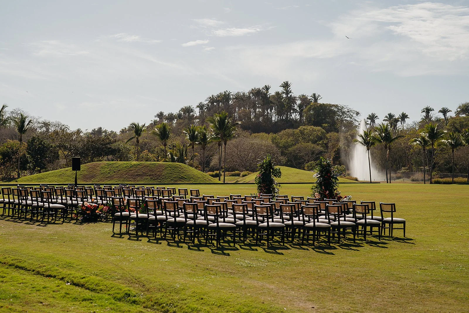 Ceremony set on the polo field with the hills behind at Tierra Tropical, San Pancho