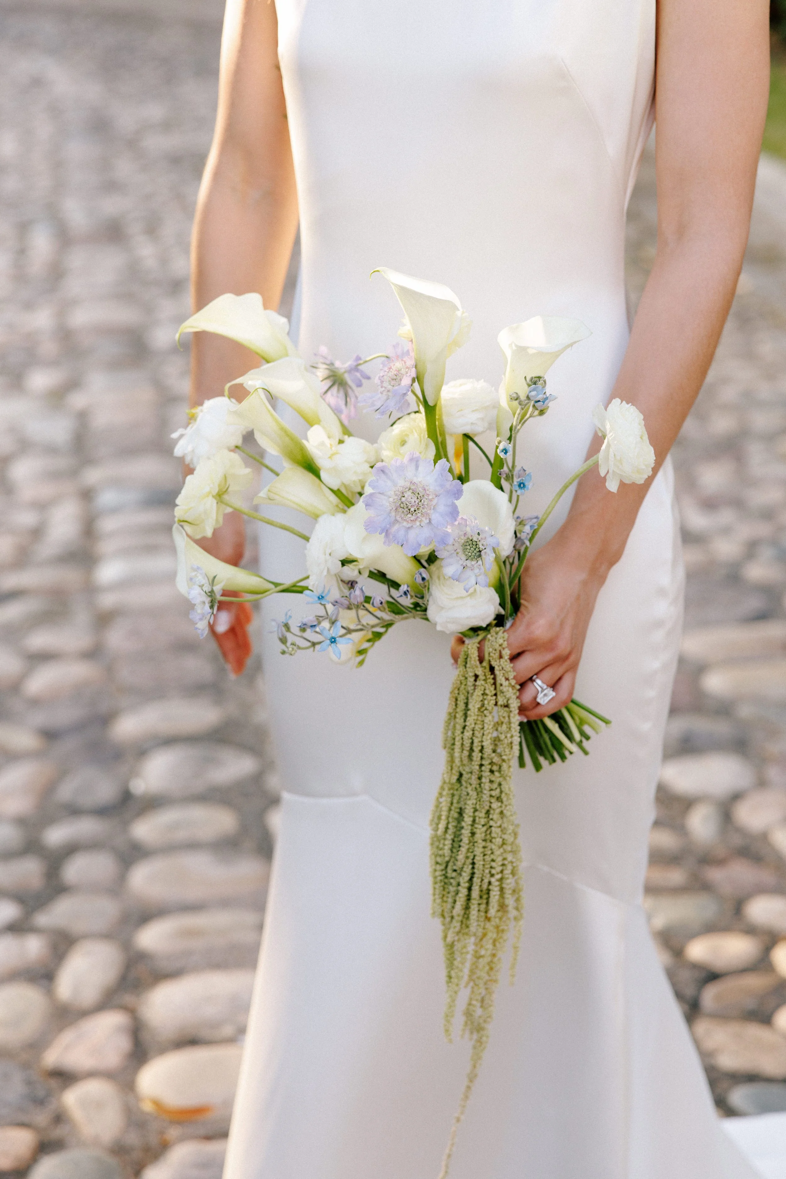 Bride carrying her calla and amaranthus bouquet at Grand Miramar, Puerto Vallarta