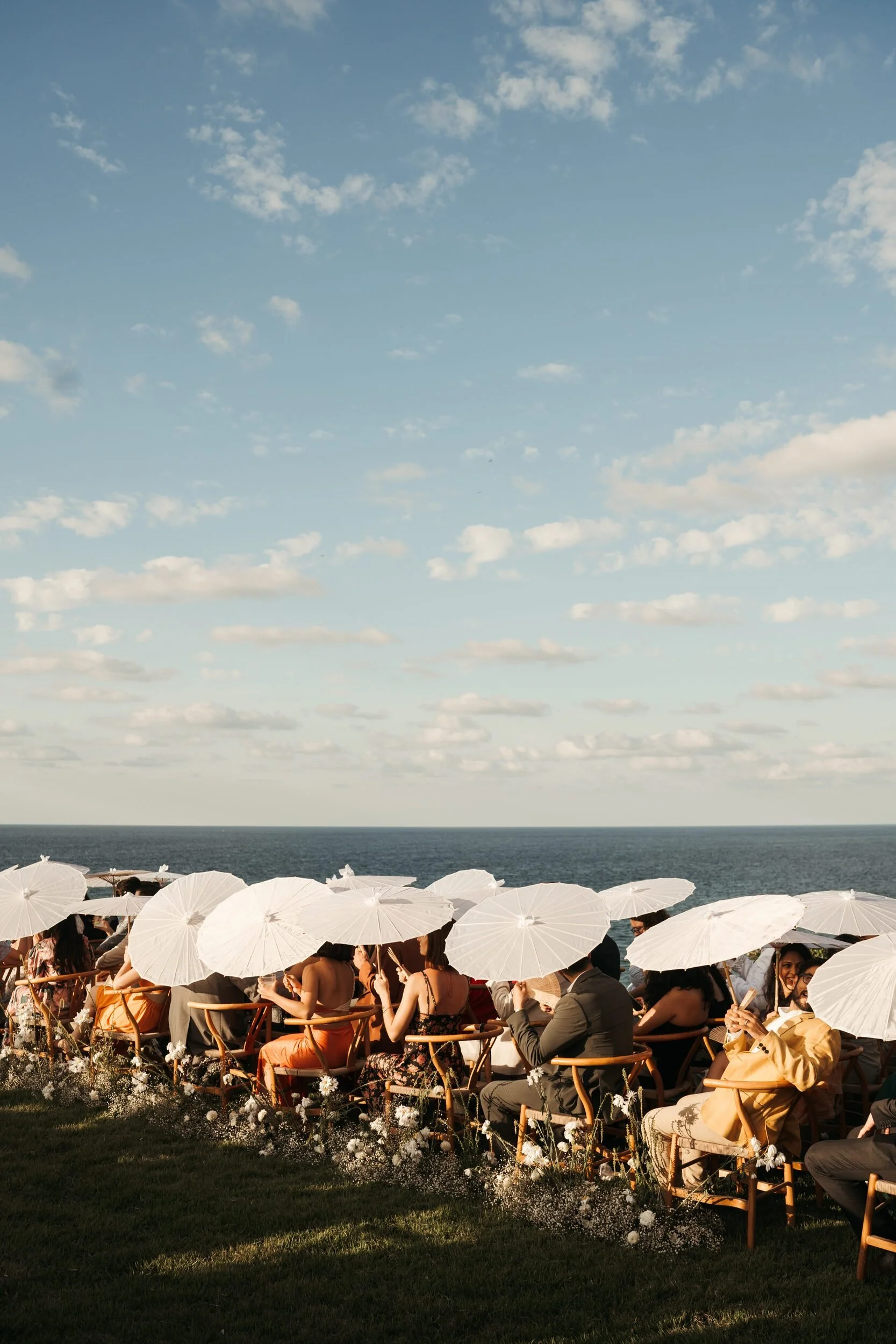 White parasols at an oceanfront wedding ceremony in Sayulita at sunset