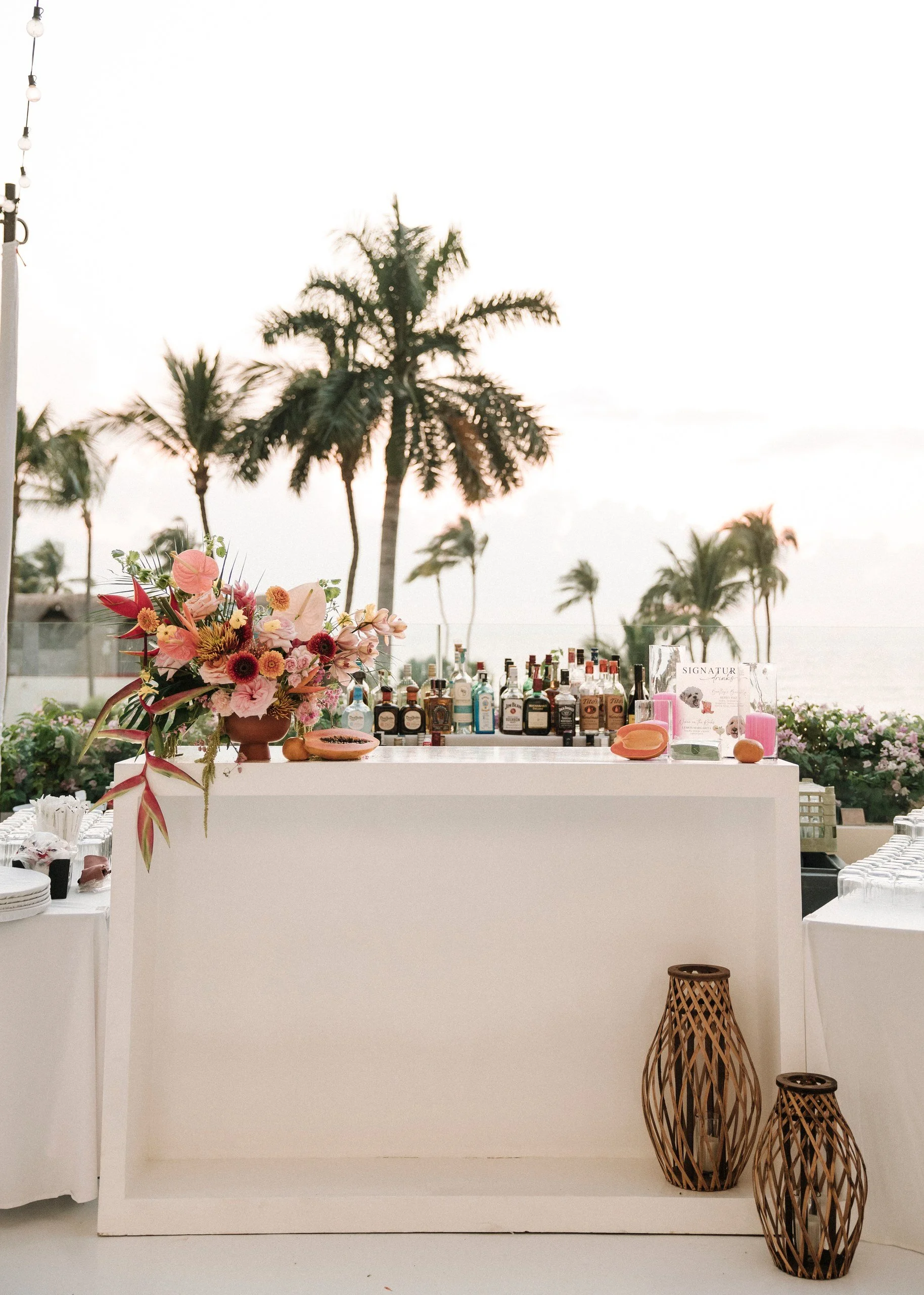 Bar with coral and peach arrangement in a terracotta vessel at Grand Velas Riviera Nayarit