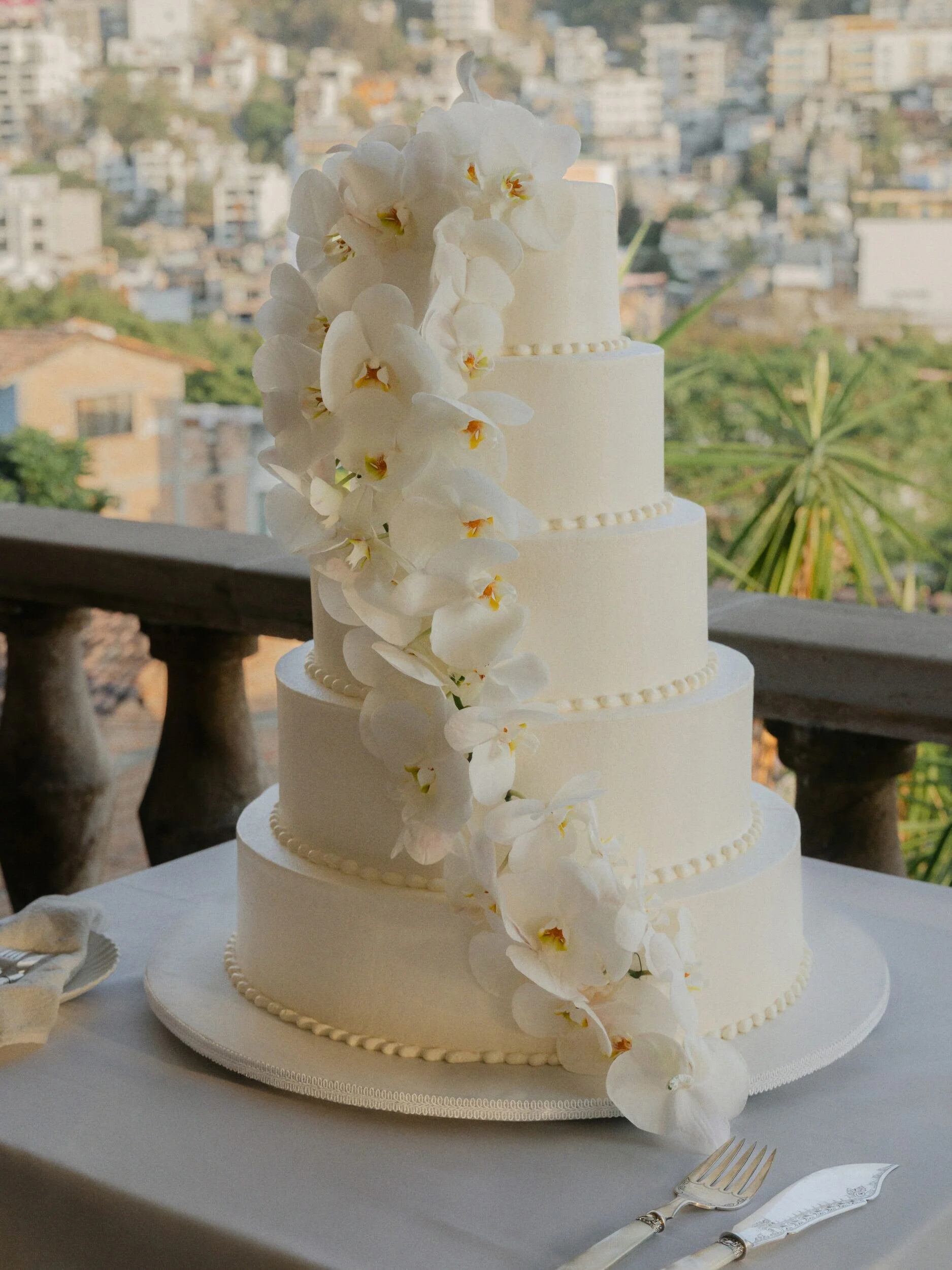 Wedding cake with cascading white orchids at Casa Kimberly, Puerto Vallarta