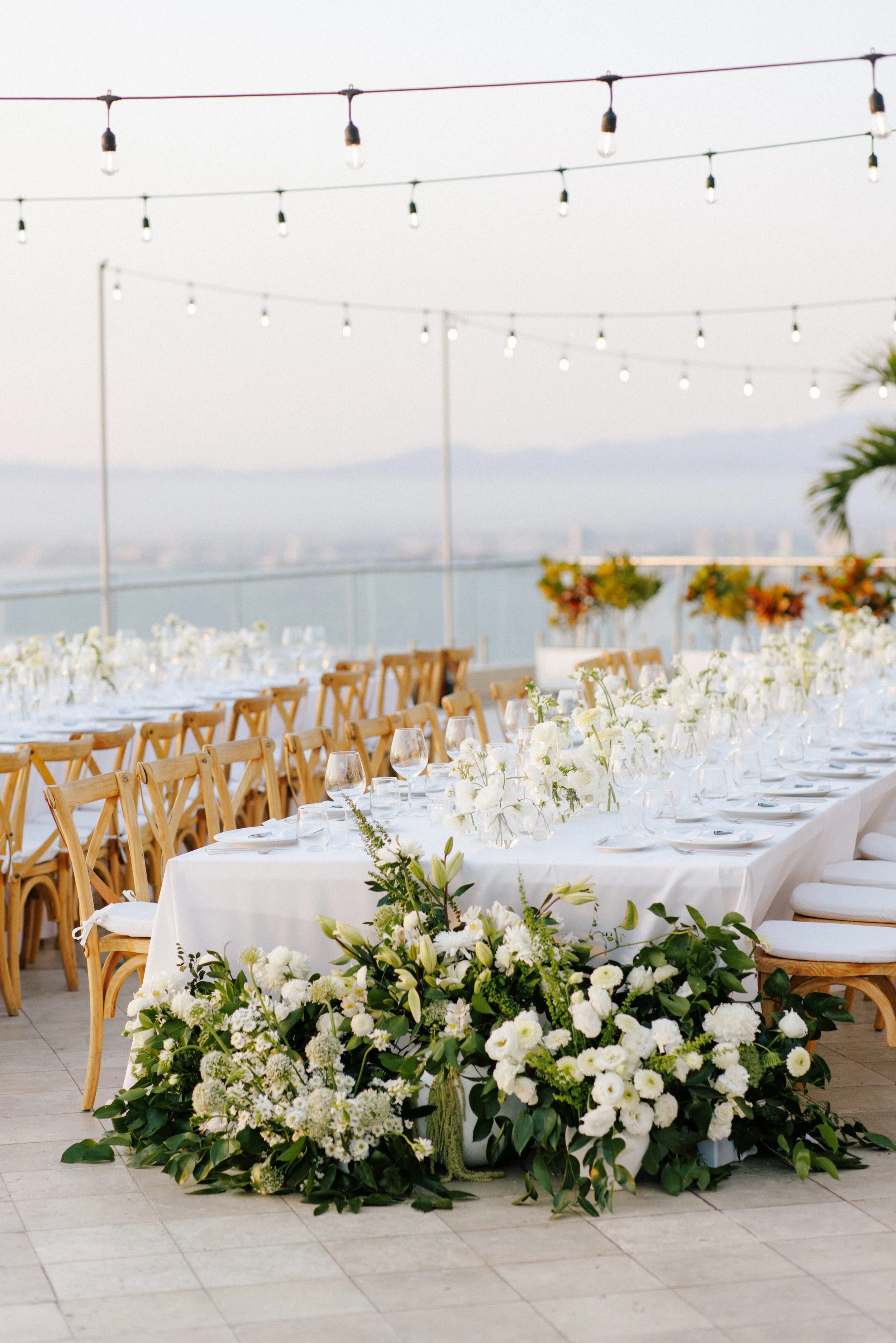 Reception table with a grounded white garland at Grand Miramar, Puerto Vallarta