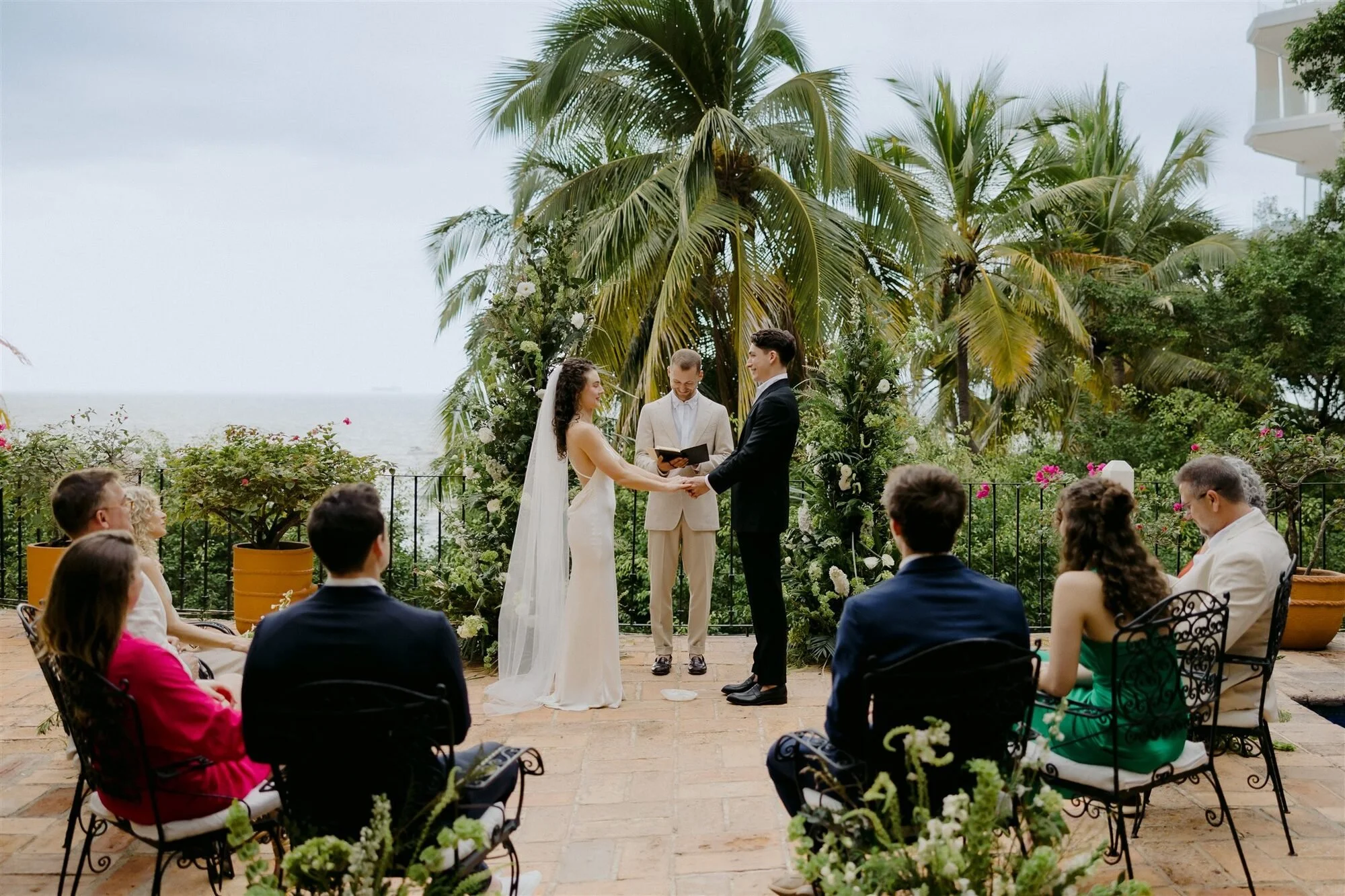 Bride and groom exchanging vows by the sea at Quinta de Los Leones, Puerto Vallarta