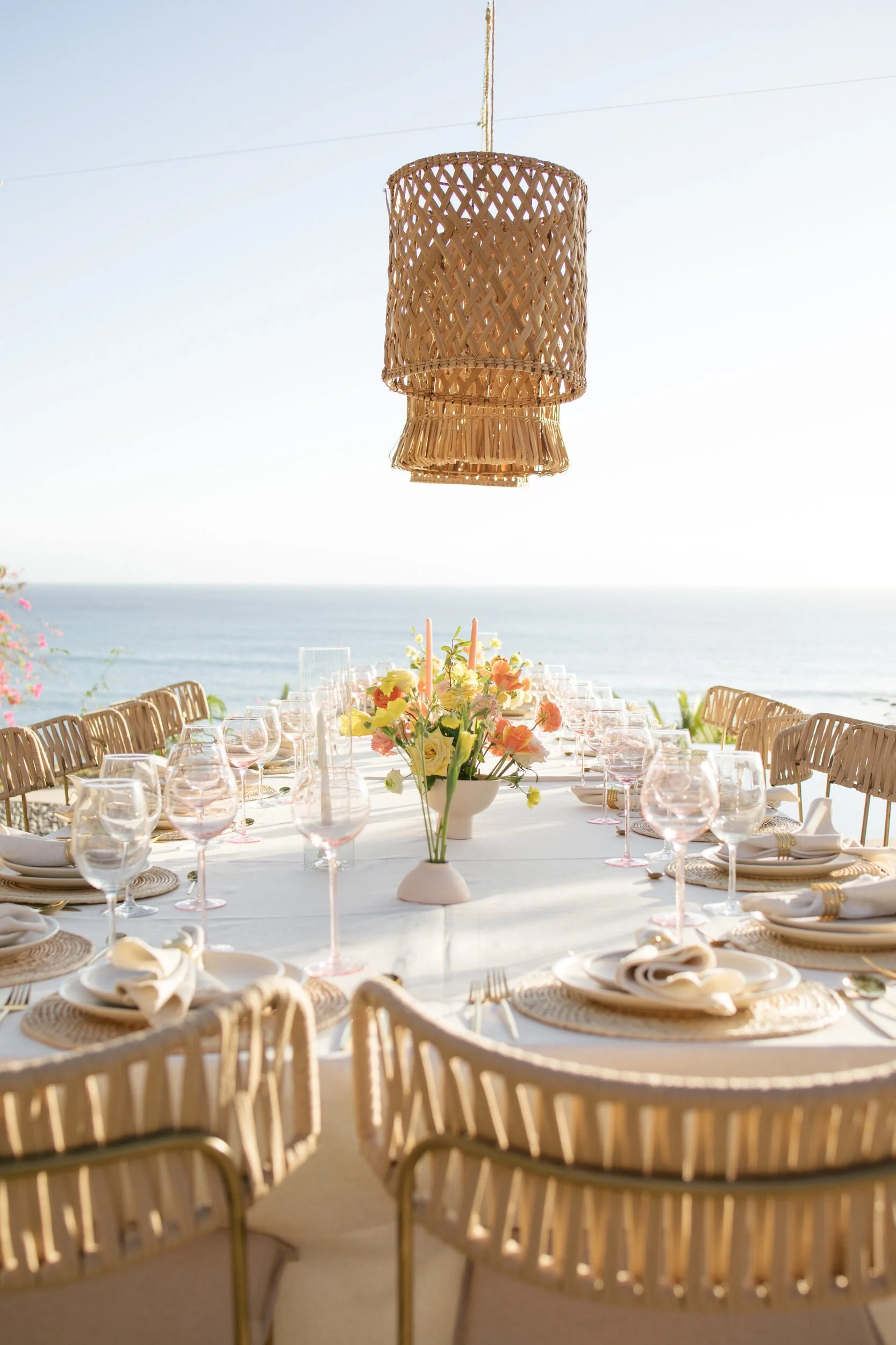 Rattan pendant above a citrus tablescape at sunset, Punta de Mita