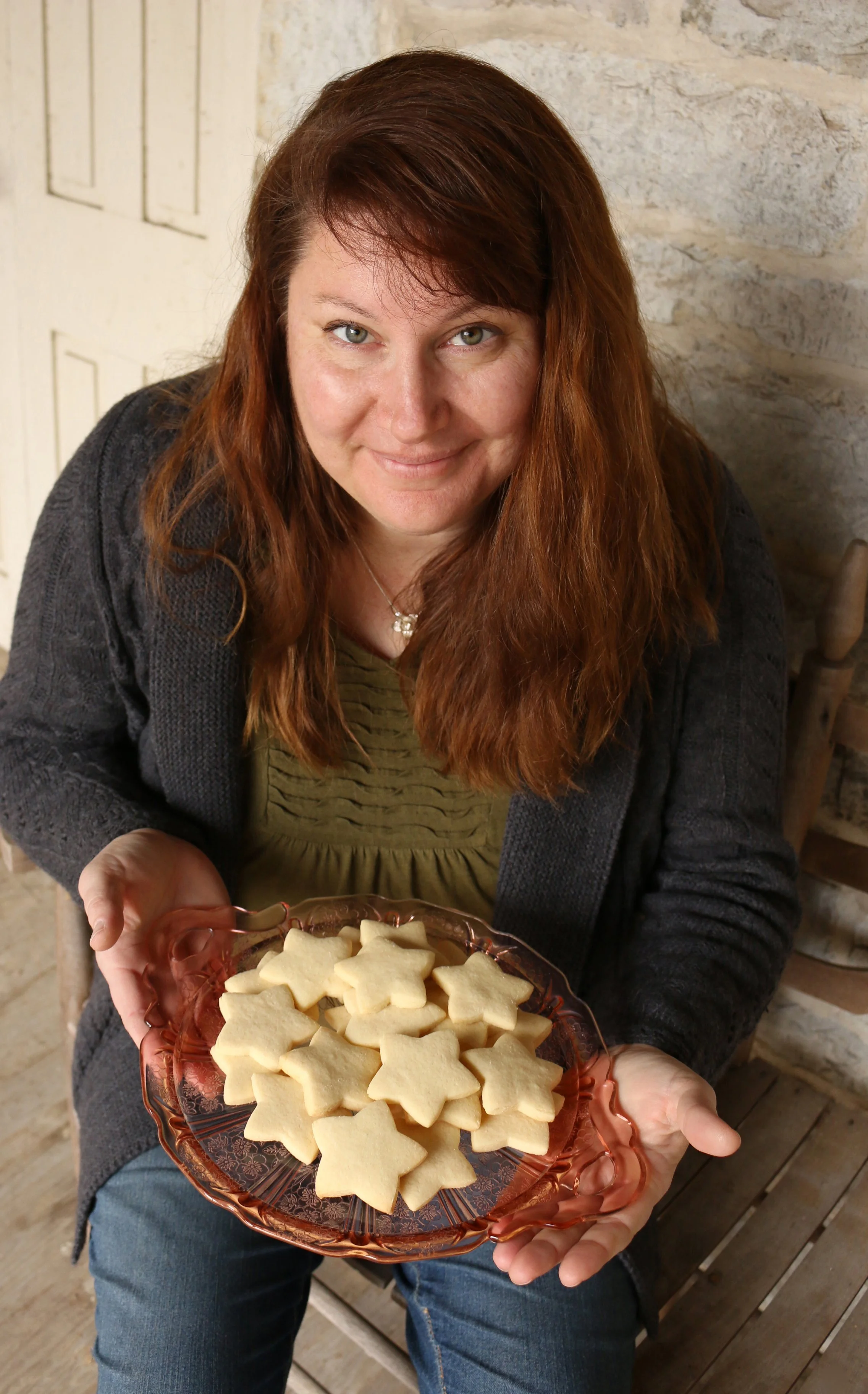 Valerie J. Frey holding a plate of star-shaped cookies.