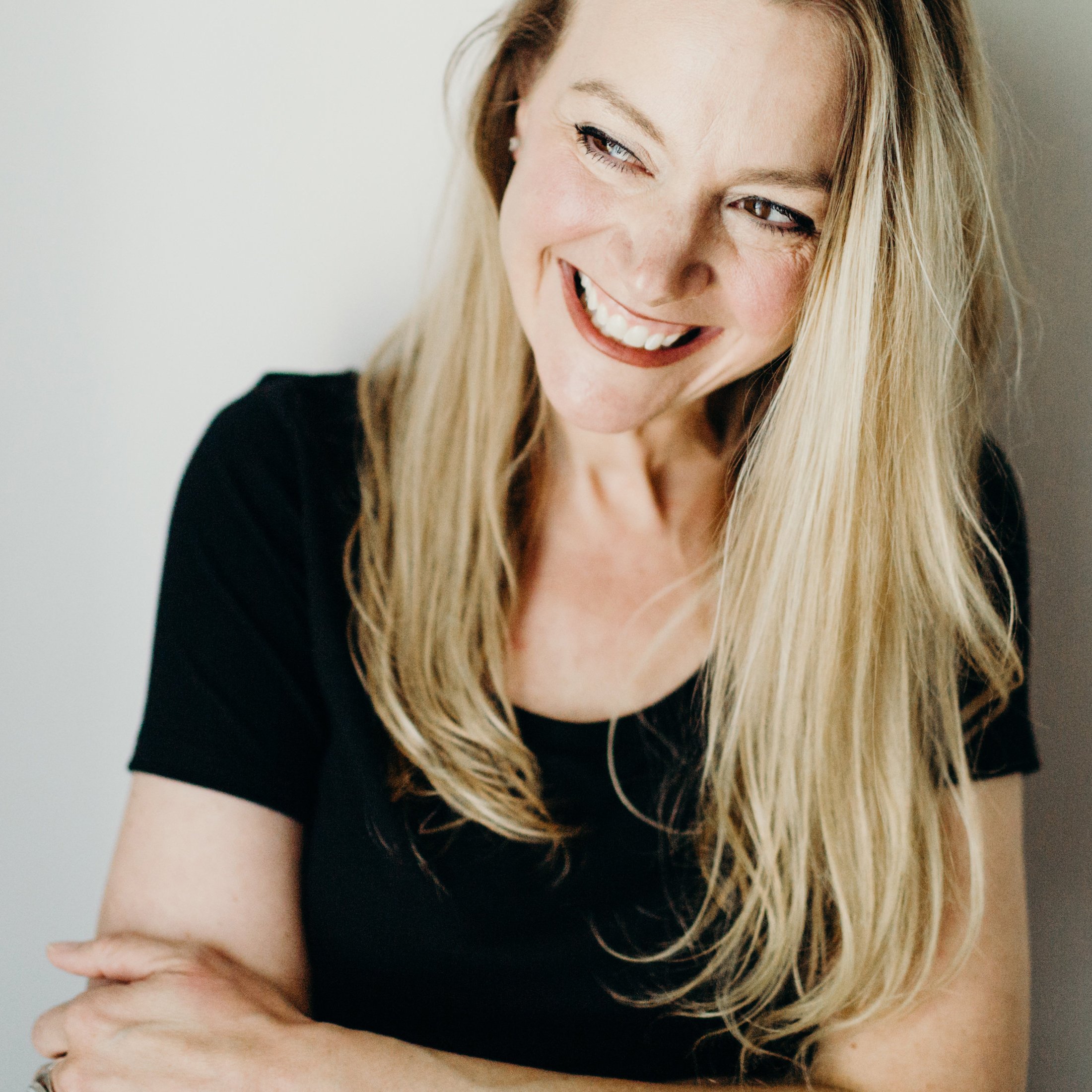 Kristin Robertson smiling and looking to her right.