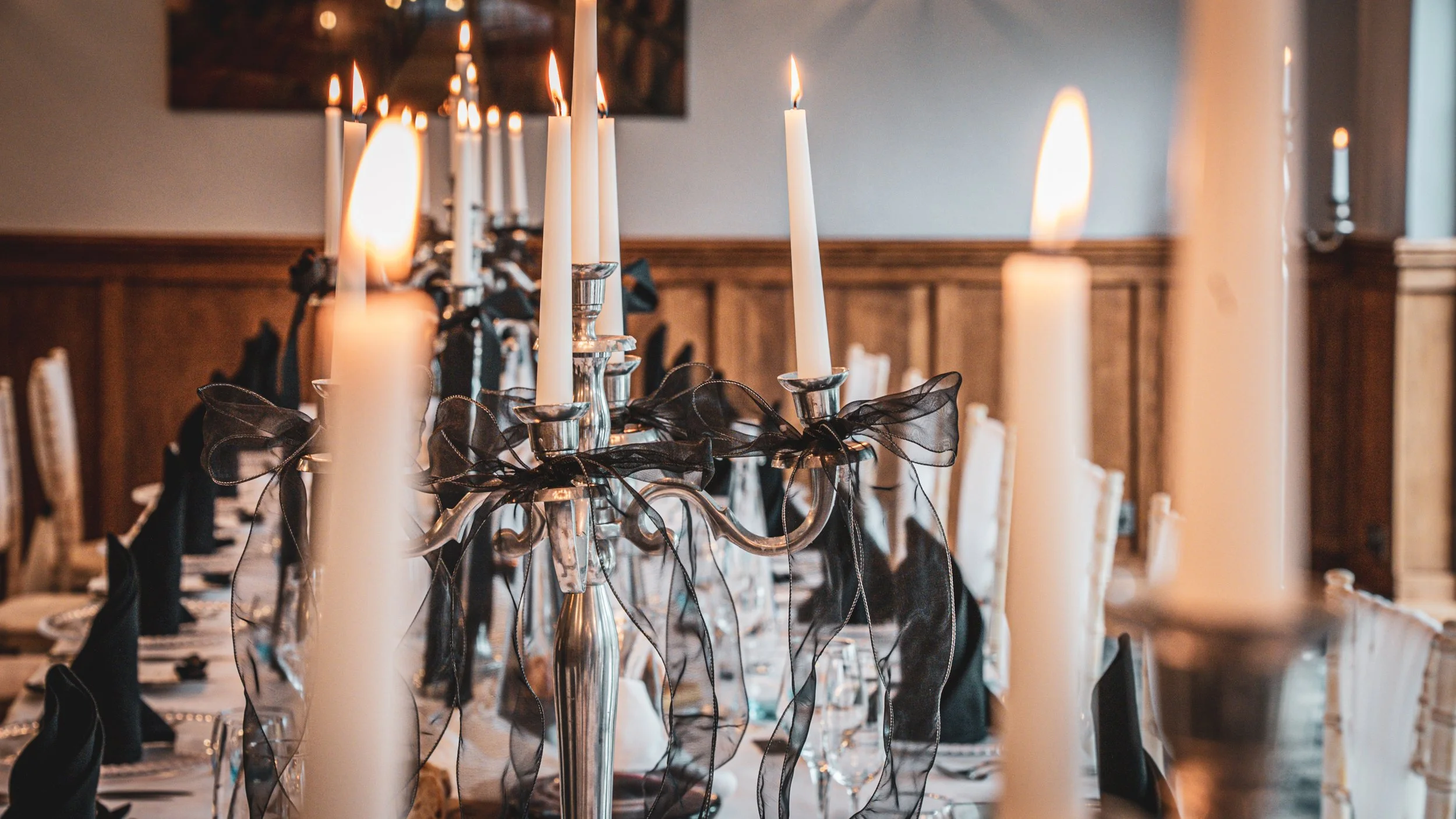 Table set for private lunch with wine glasses and candles