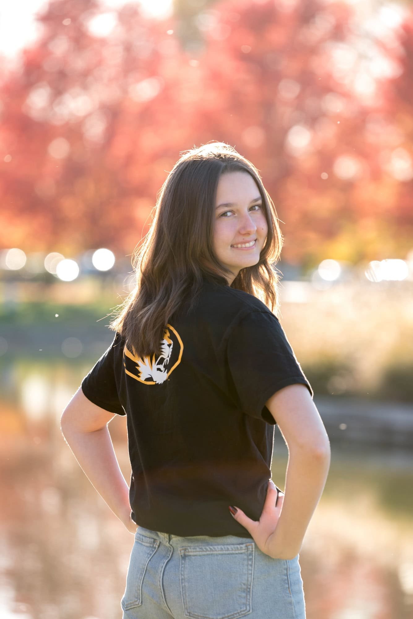 Across from The Muny during the fall, a senior girl looks back over her shoulder showing off her Mizzou shirt.